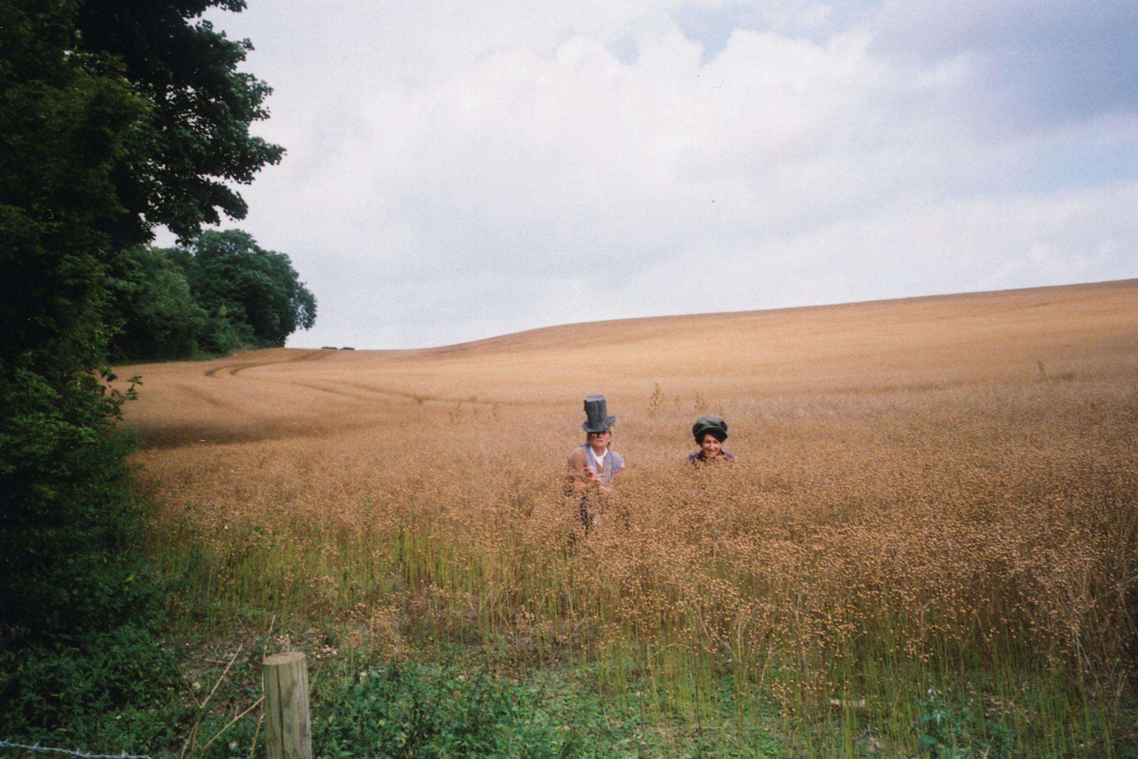 Film photograph of two people in high grass in a field 