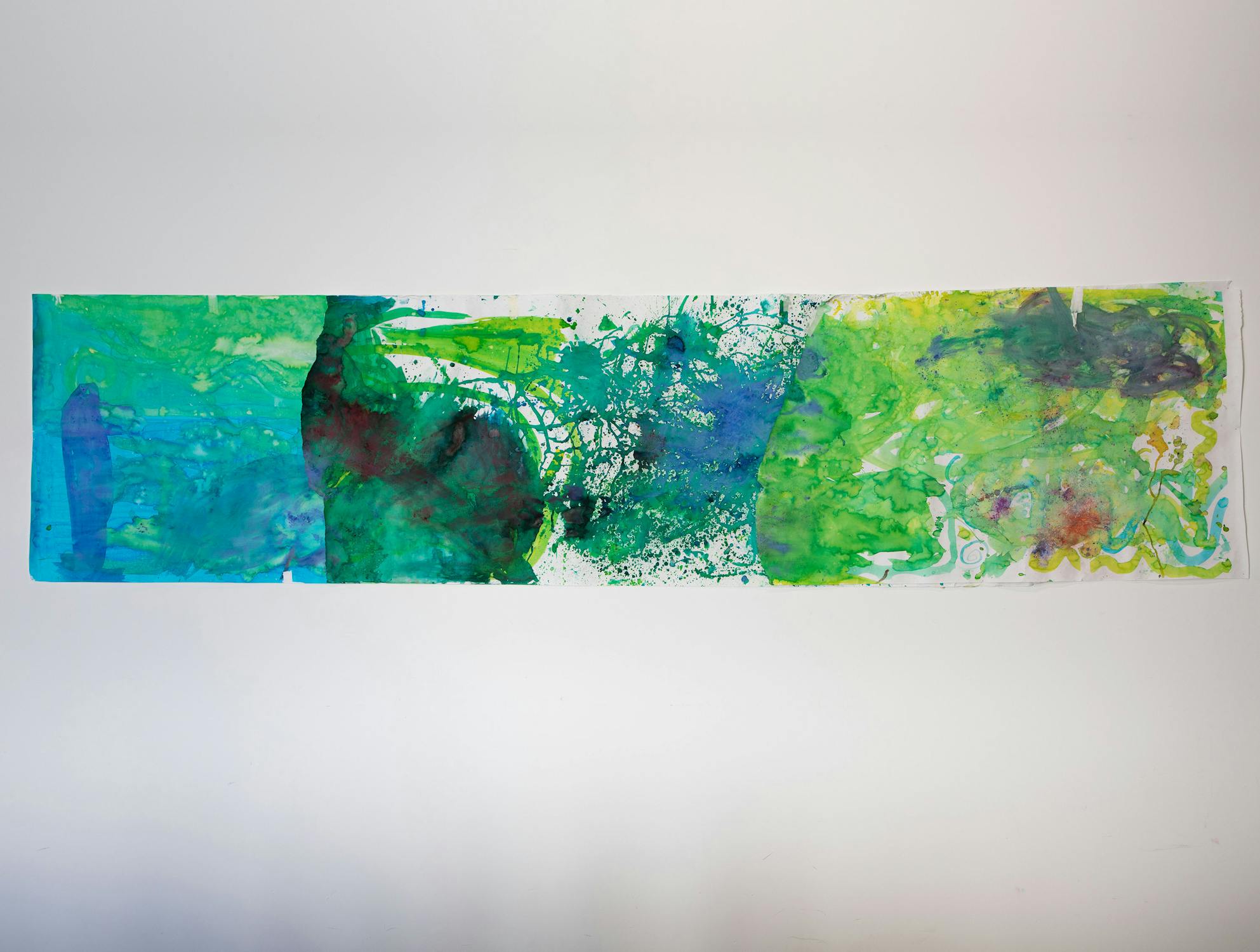 A horizontal abstract painting with blue, green, yellow, and splashes of red, featuring blended watercolour textures and splotches on a white background.