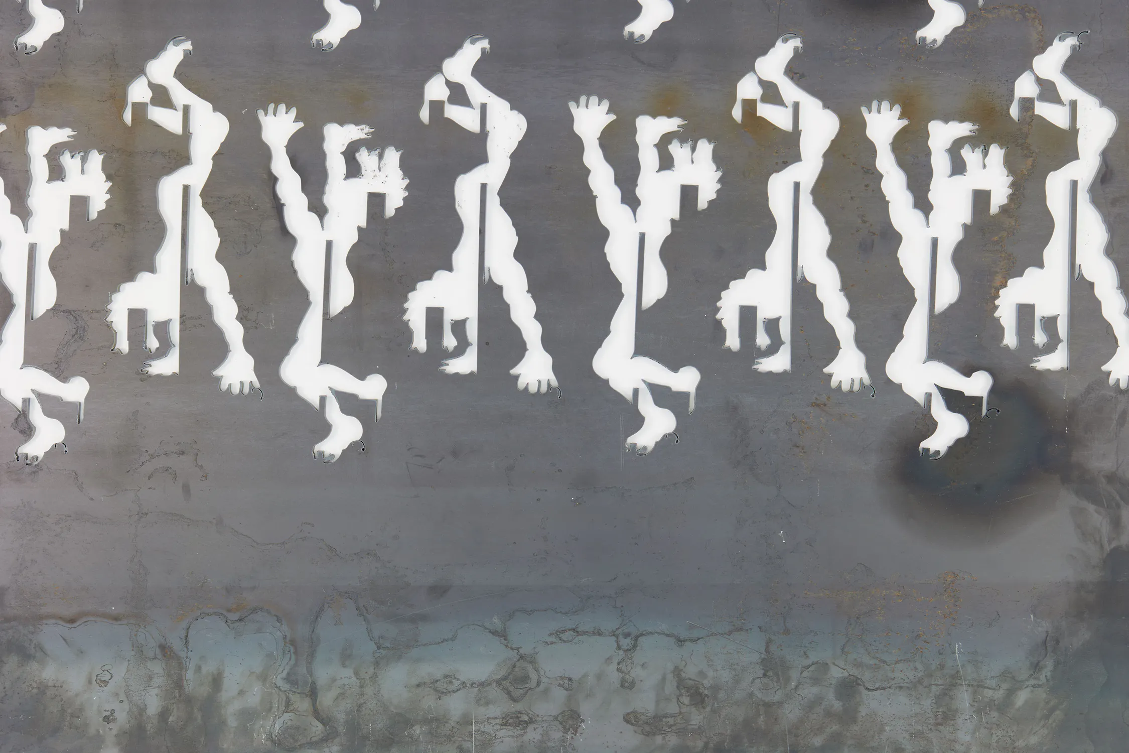 White silhouettes of abstract human-like figures with raised arms are arranged in repeating vertical rows on a weathered, grey background that fades into blue and brown tones at the bottom. The figures appear to be walking or moving energetically.