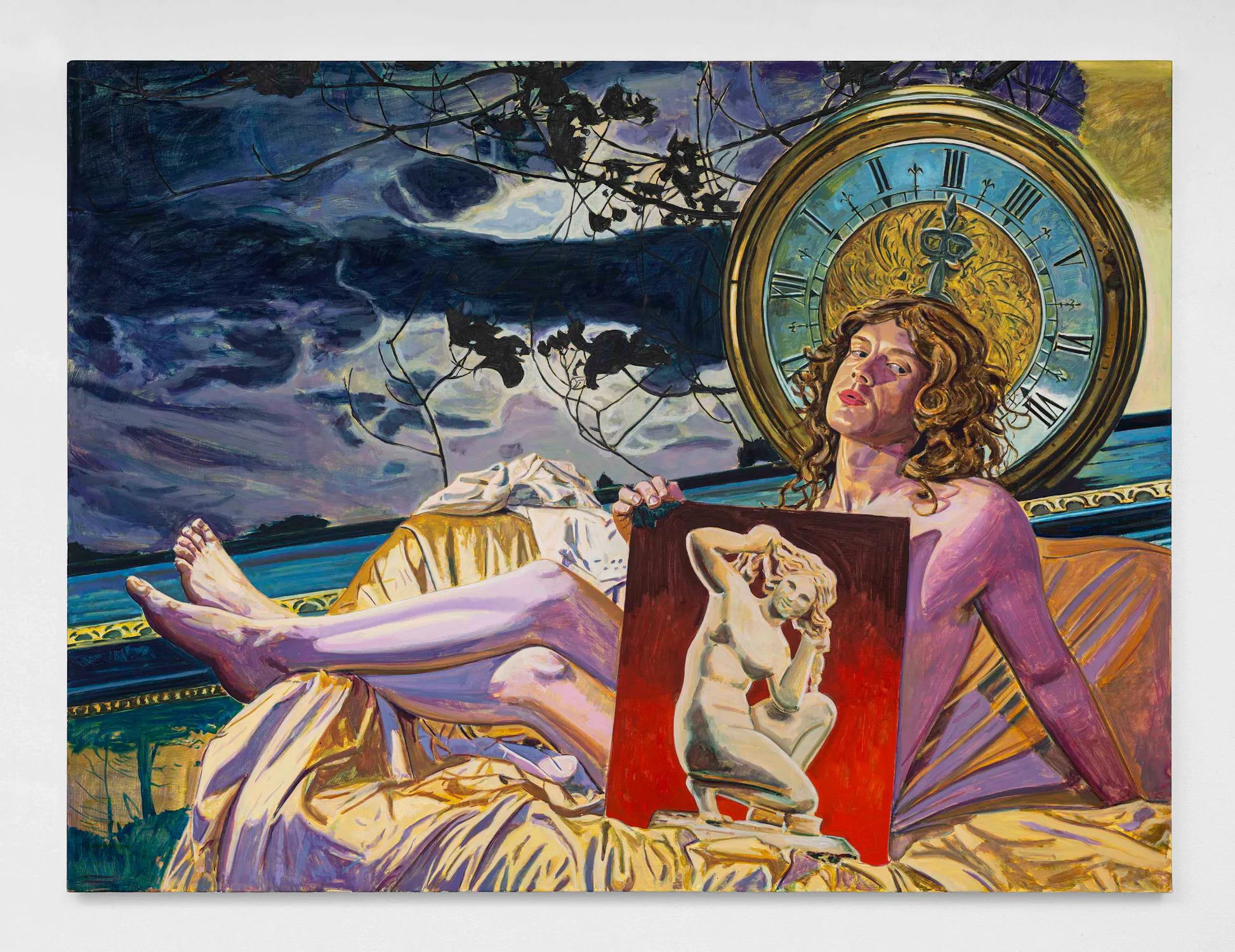 A person with curly hair and flushed cheeks lounges on gold fabric beneath a large ornate clock, holding a painting of a white classical statue. The sky behind them is dramatic and stormy, with dark clouds and silhouetted tree branches.