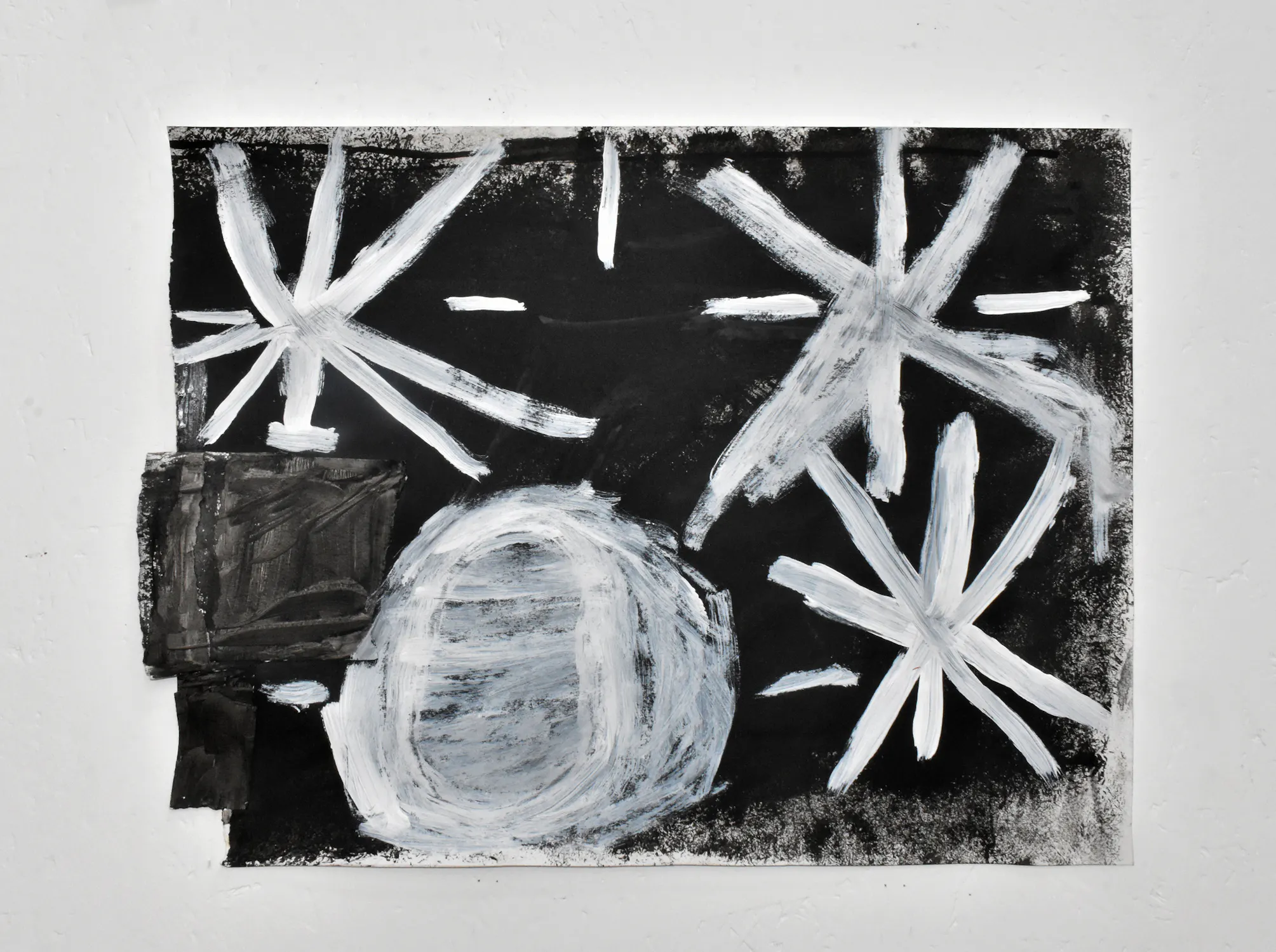 A painting on black paper by James Heath shows large, rough white brushstrokes forming three starbursts and a textured circle. Smaller white lines and a dark rectangle appear on the left. The artwork has a childlike, abstract, celestial theme.