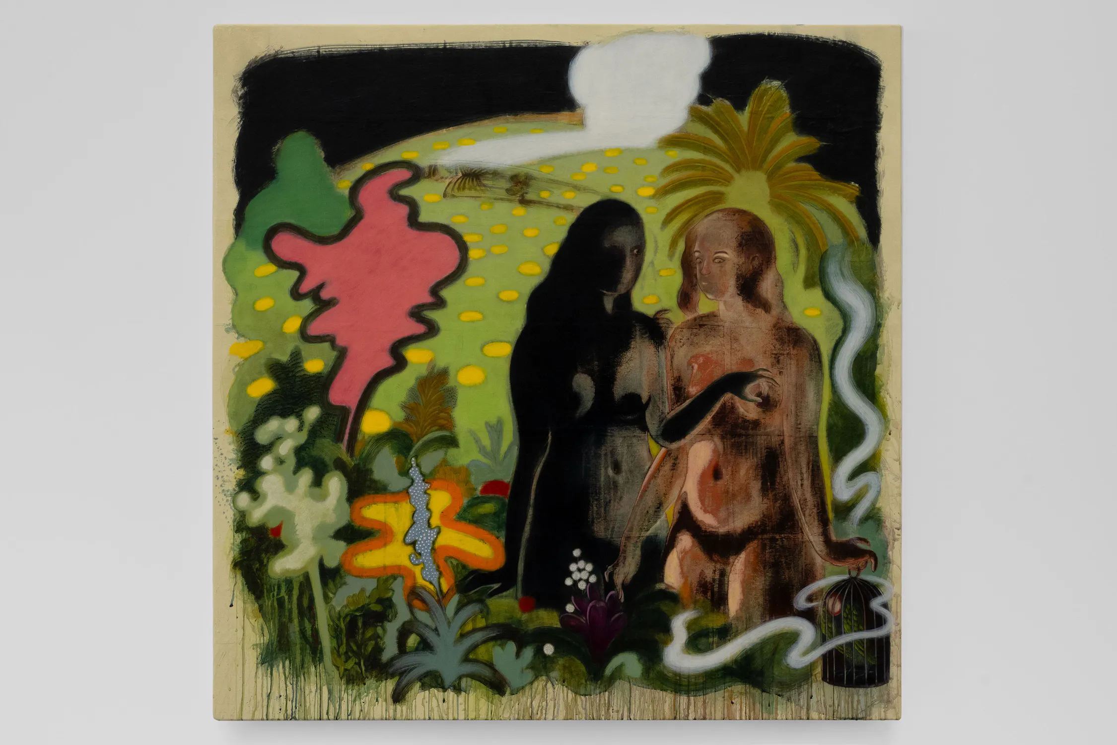 A colourful painting hangs on a white wall, depicting two human-like figures—one dark, one nude—surrounded by surreal plants, abstract shapes, and a white sun or moon in a yellow sky. The artwork features bold outlines and a dreamlike, mystical atmosphere.