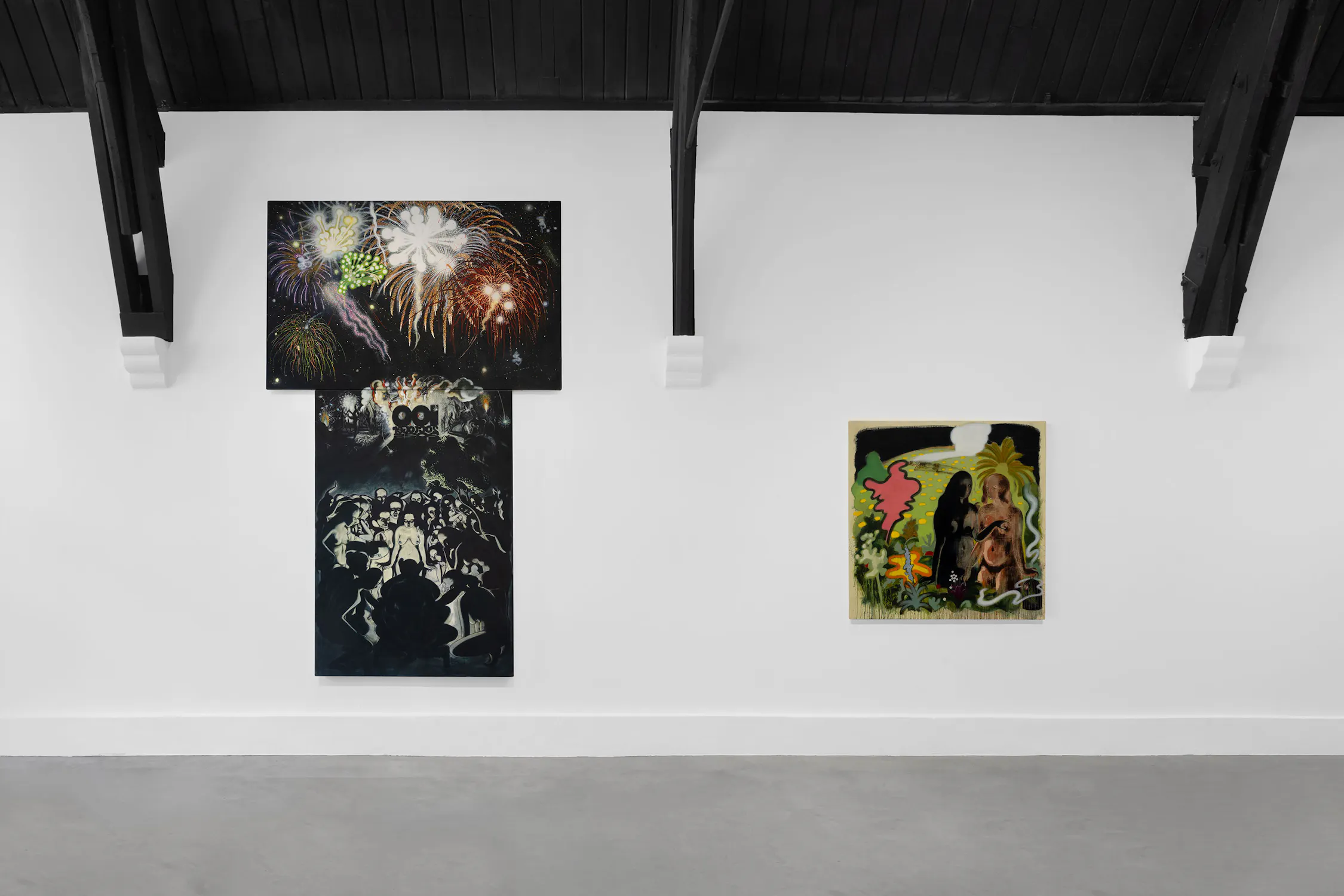 A white gallery wall displays two artworks by T. Venkanna: on the left, a two-part dark painting with fireworks and a crowd; on the right, a smaller canvas featuring two silhouetted figures among bold, colourful, foliage-like shapes under a white circle.