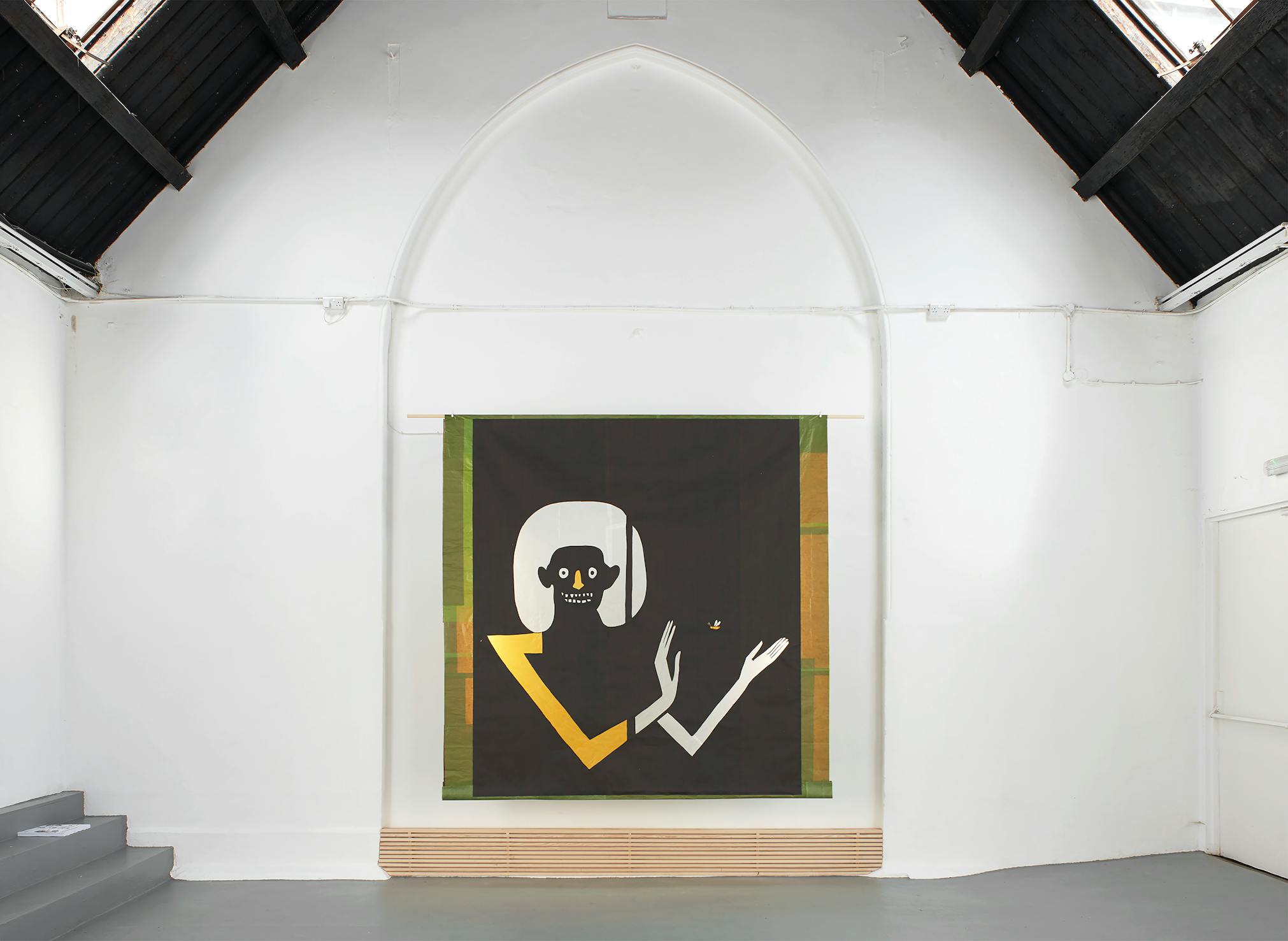 A modern art gallery with white walls and a high, vaulted black ceiling. A large artwork hangs on the wall, depicting a stylised figure with a yellow and white arm, white hair, and a black face, holding a small bird on a dark background.