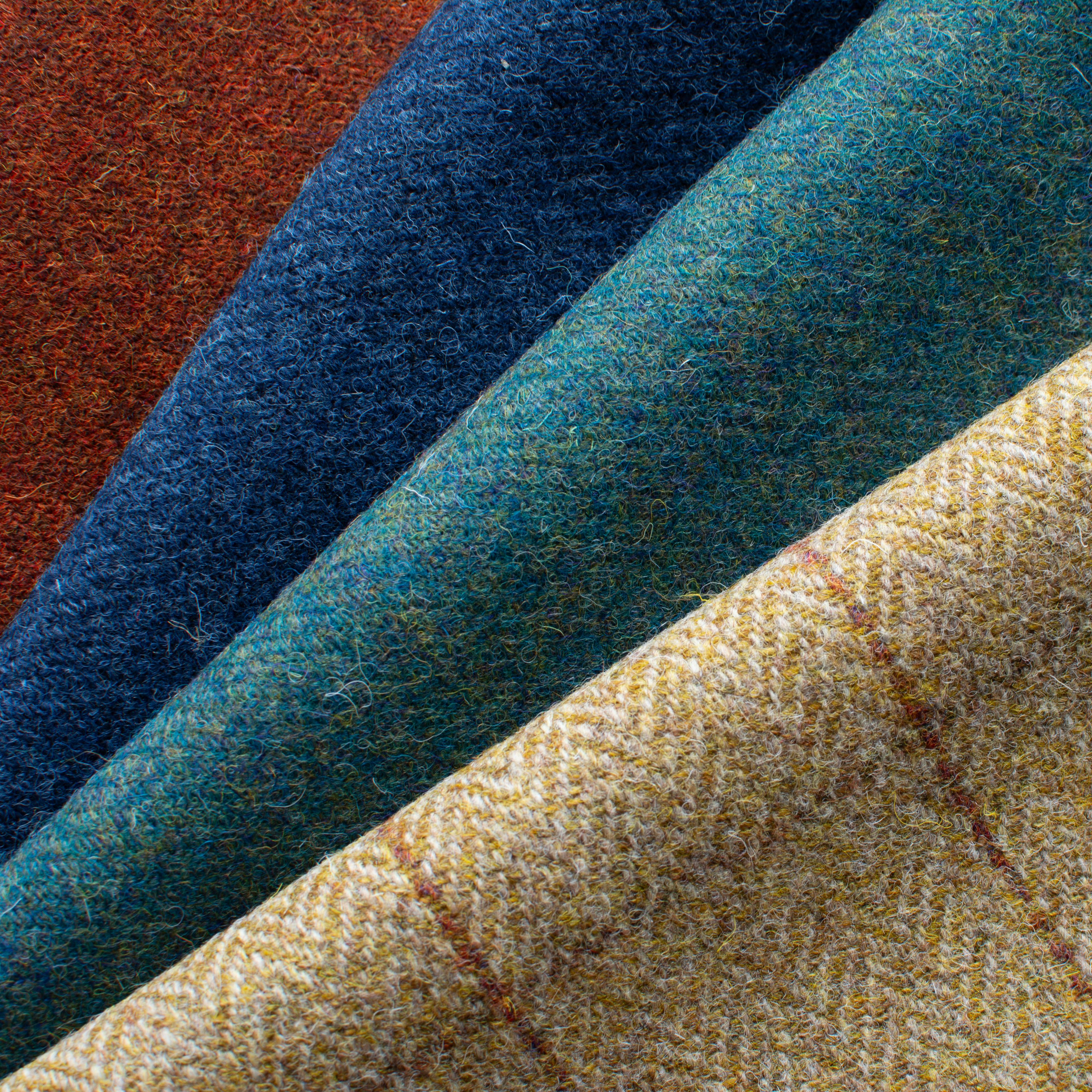 Collection of high-quality suit fabrics in different colors and patterns.