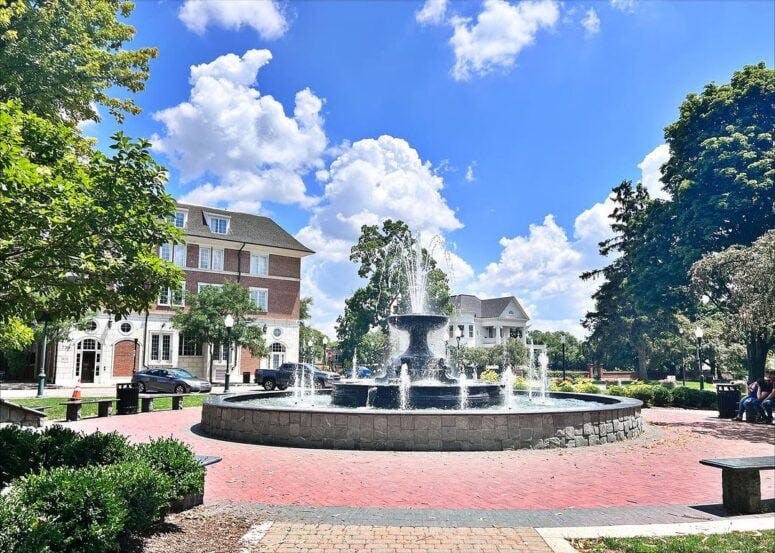 Outdoor scene of Kellogg Park in Plymouth, Michigan, highlighting the iconic fountain and park setting.