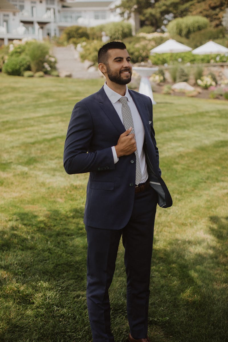 Man in a navy blue suit heading to a special event or work.