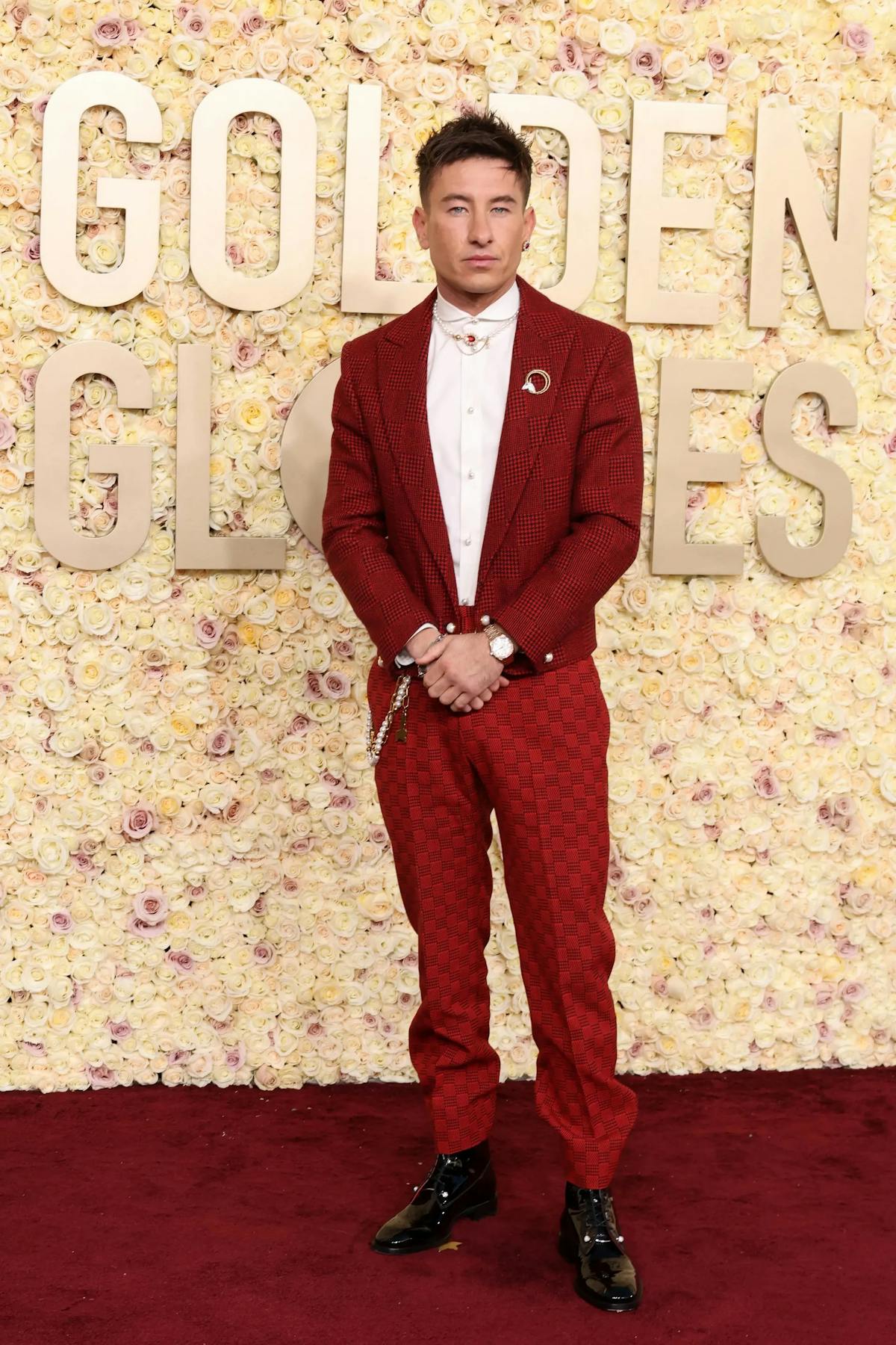 Barry Keoghan wears a red patterned tuxedo to the Golden Globes 2024 awards show for bold red carpet style.