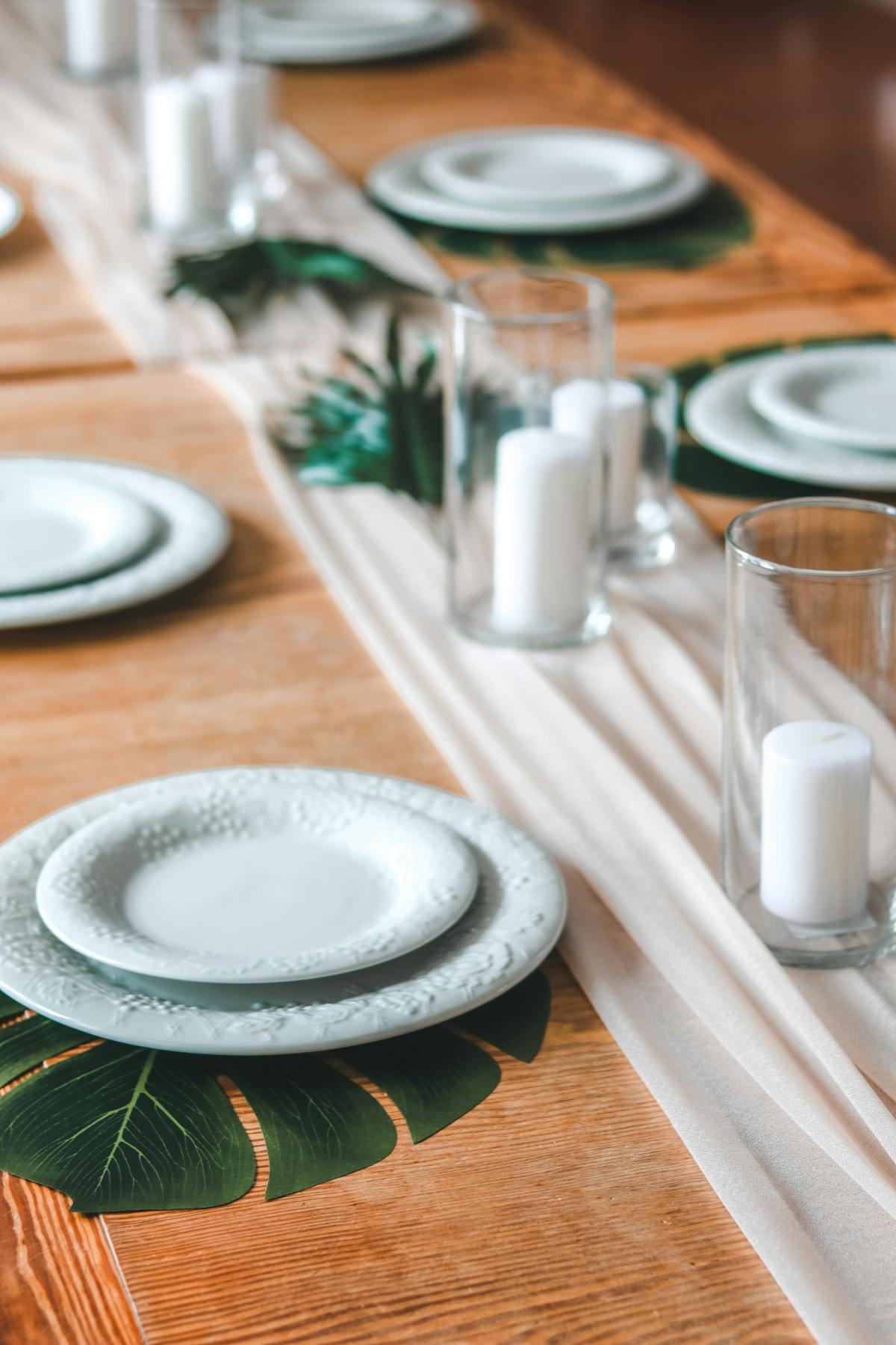 Custom tropical table setting with monesterra leaves and candles