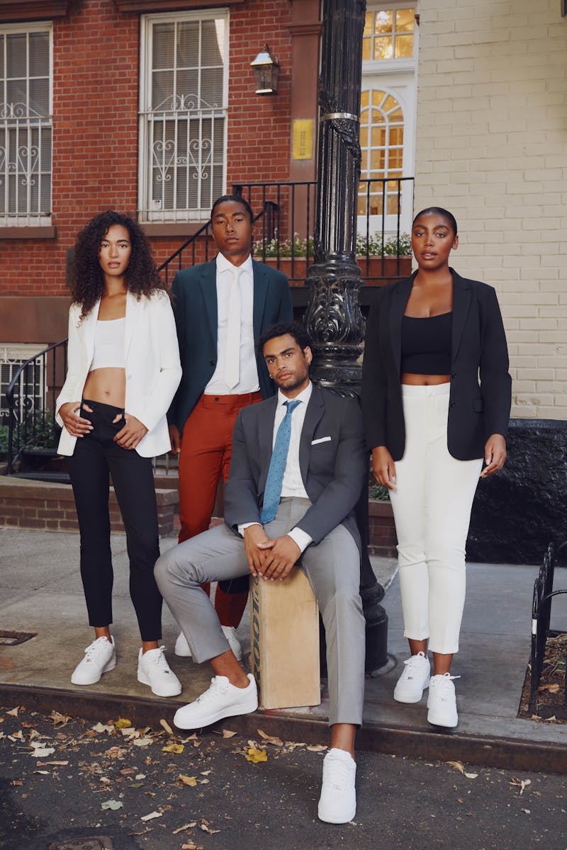 Fashionable group of men and women on New York City street in style wearing suit separates and mix and match suit colors for summer.