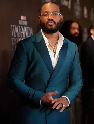 Ryan Coolger in a deep teal tuxedo at the Wakanda Forever premiere.