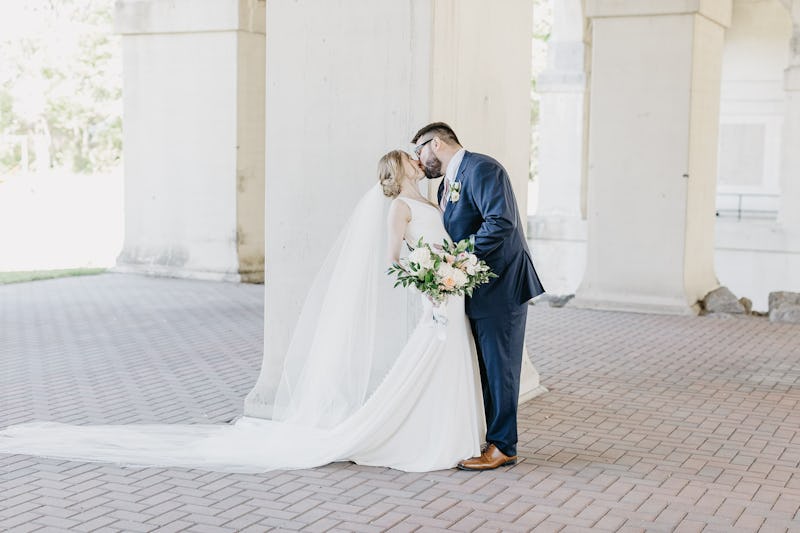 Bride and Groom Kissing in Navy Blue Suit