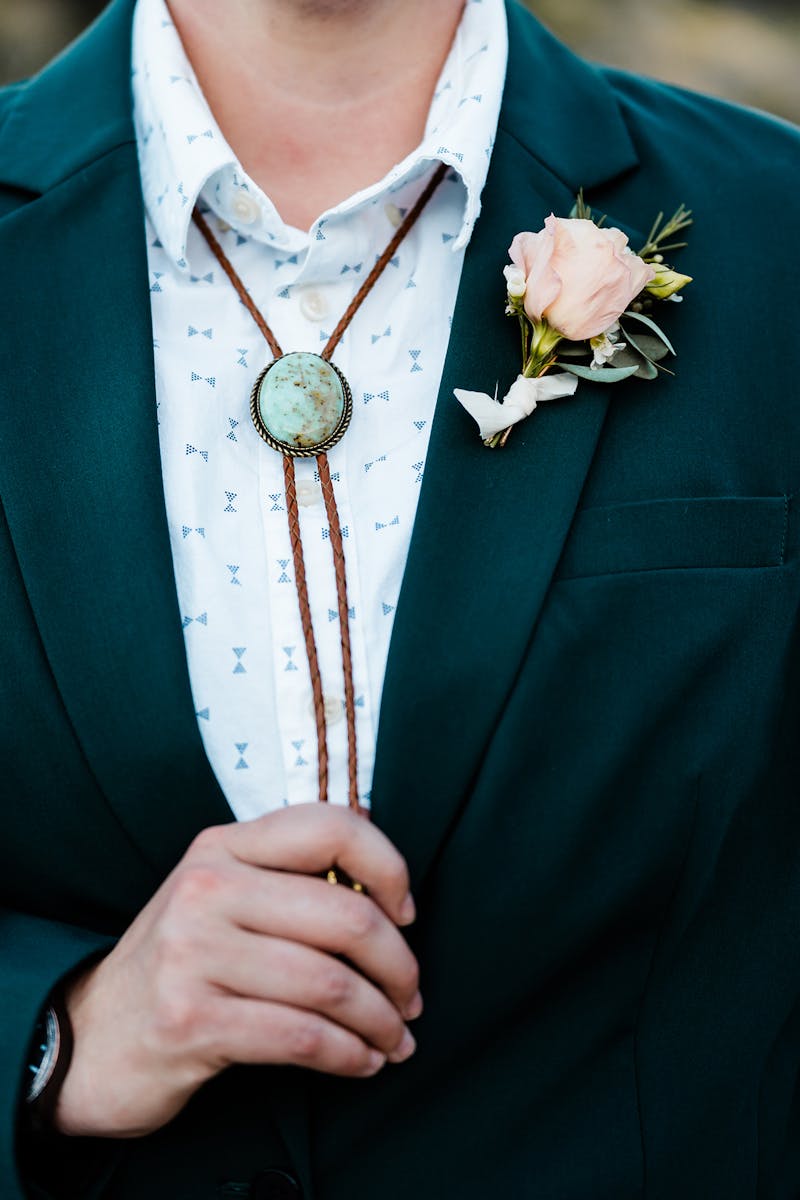Wedding bolo tie paired with women's suit for masc bride outfit.