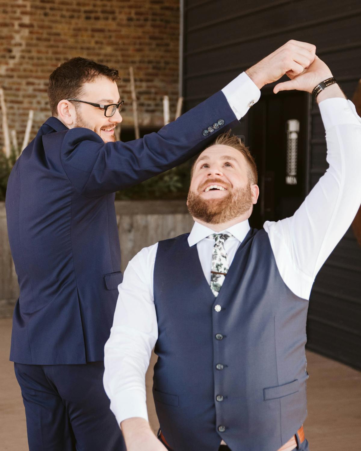 Two friends dancing and twirling each other as mother-son dance alternative for wedding where parent has passed away.