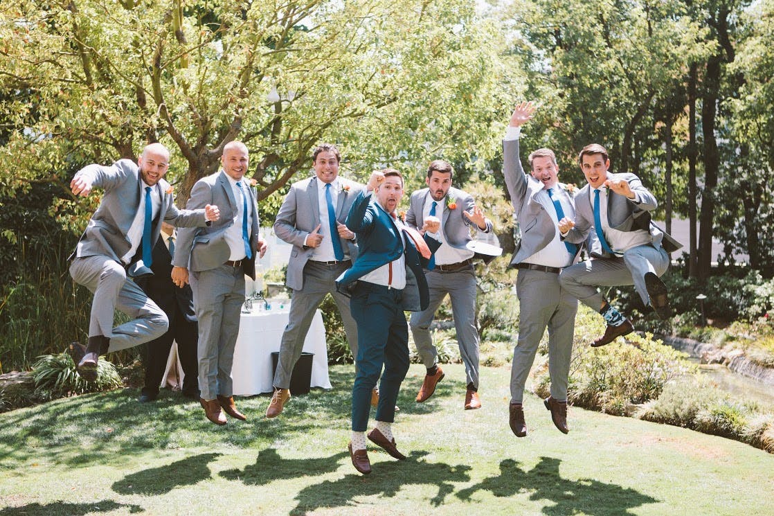 groomsmen in gray suits and brown shoes
