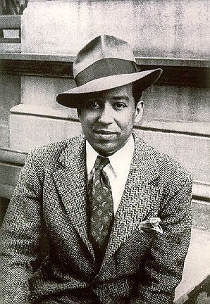 Langston Hughes fashion with Harlem Renaissance style in a tweed suit and fedora.