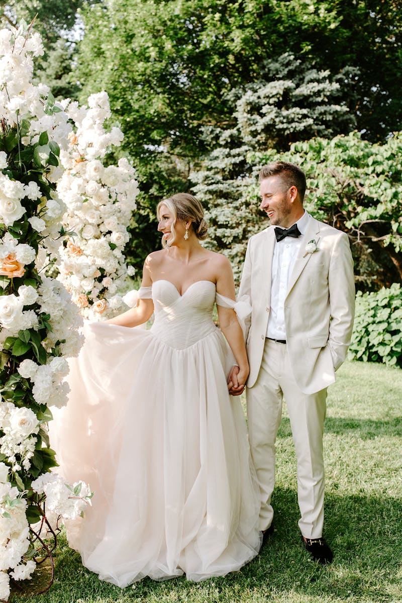 neutral bridal colors with tan groom suit and off-white bridal gown