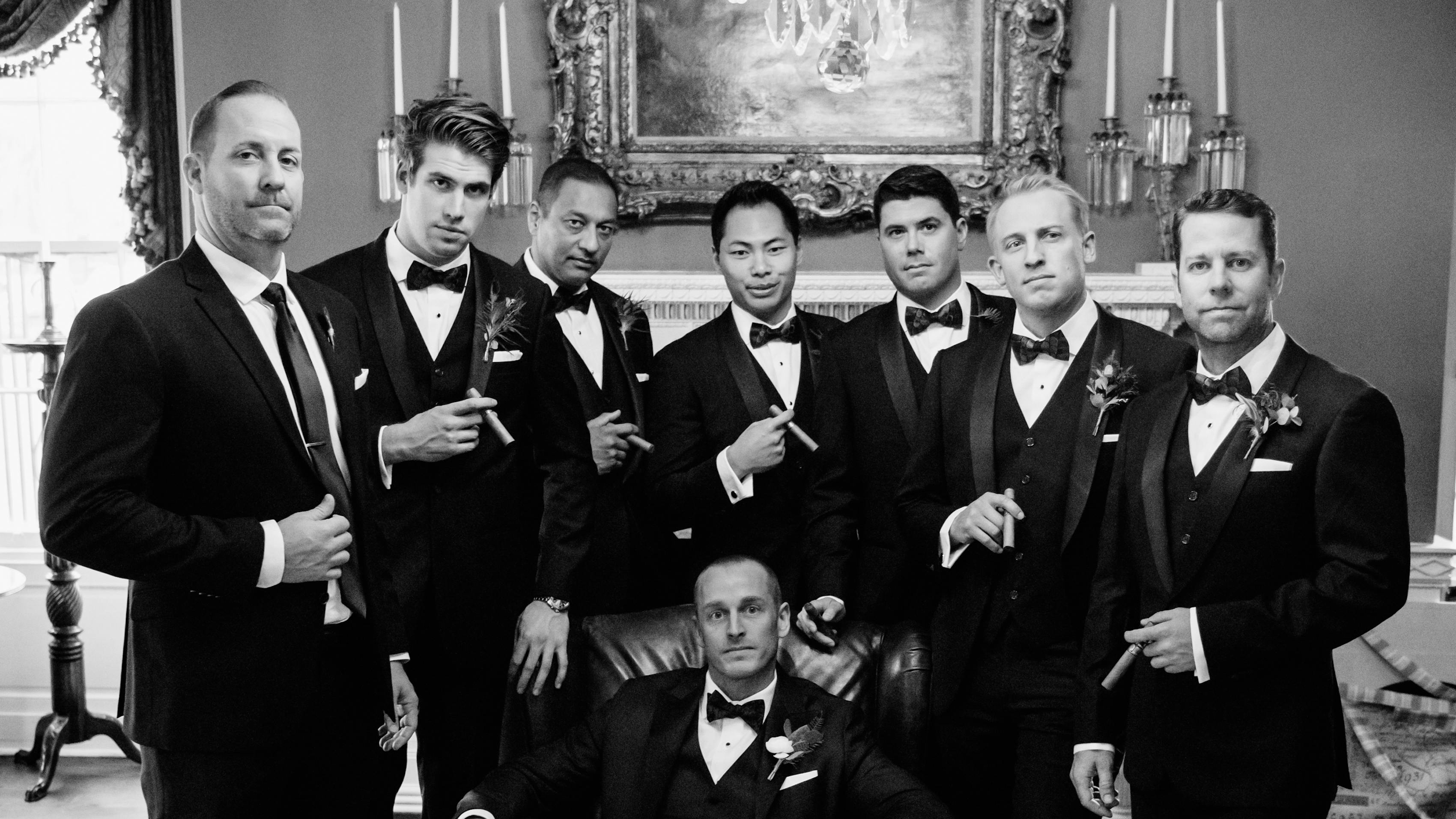 Groom and groomsmen in black tuxedos with shawl lapel
