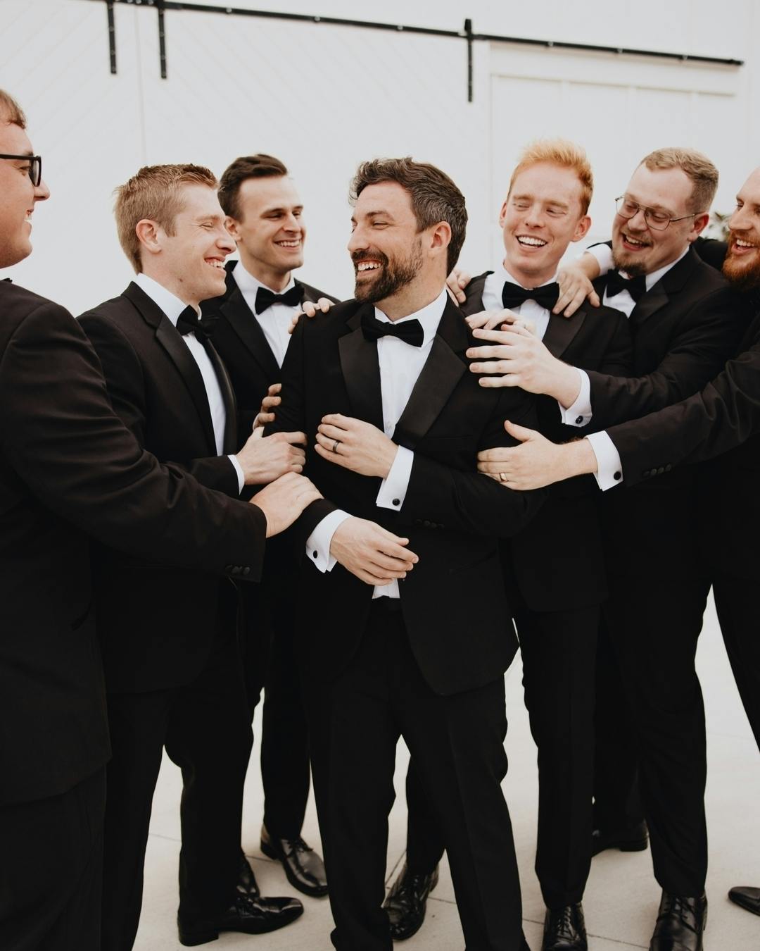 Black tie wedding attire for groomsmen wearing notch lapel black tuxedos for men