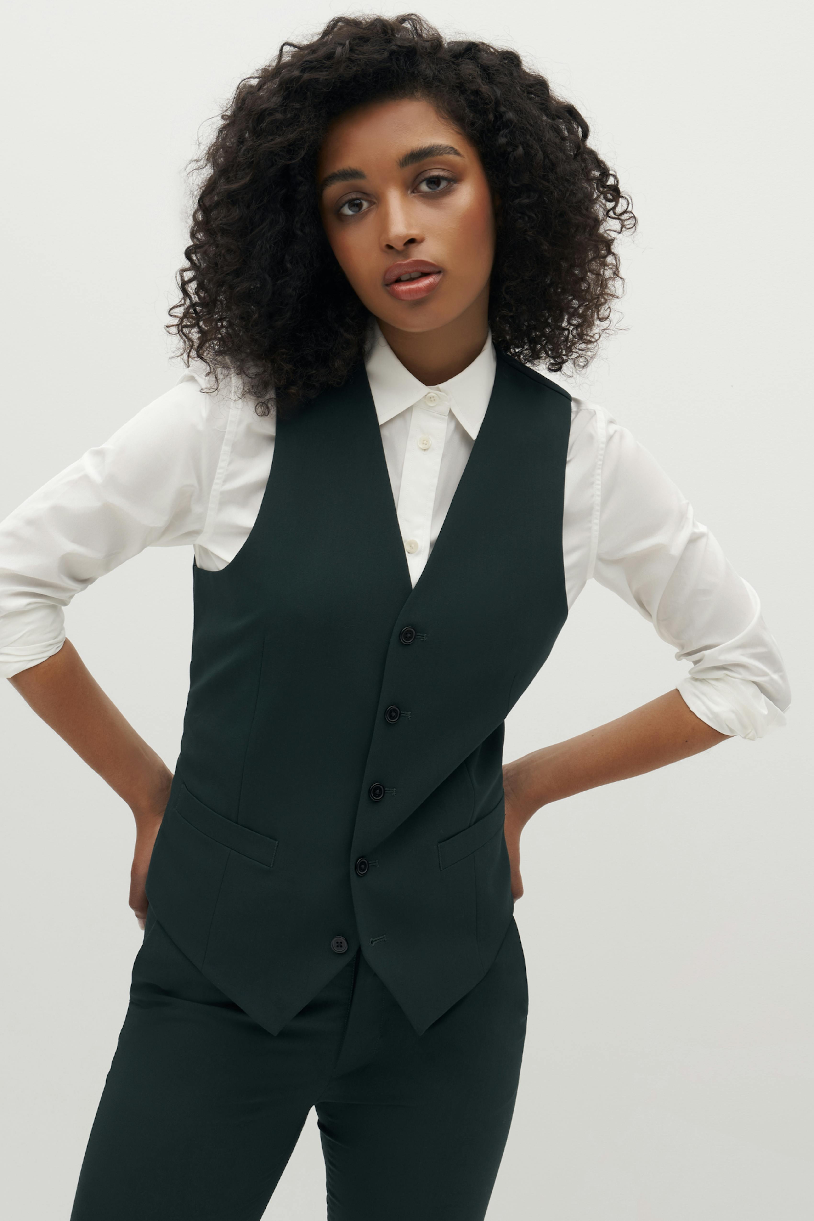 Streetstyle homecoming 2022 look with women's dark green suit vest coordinated set.