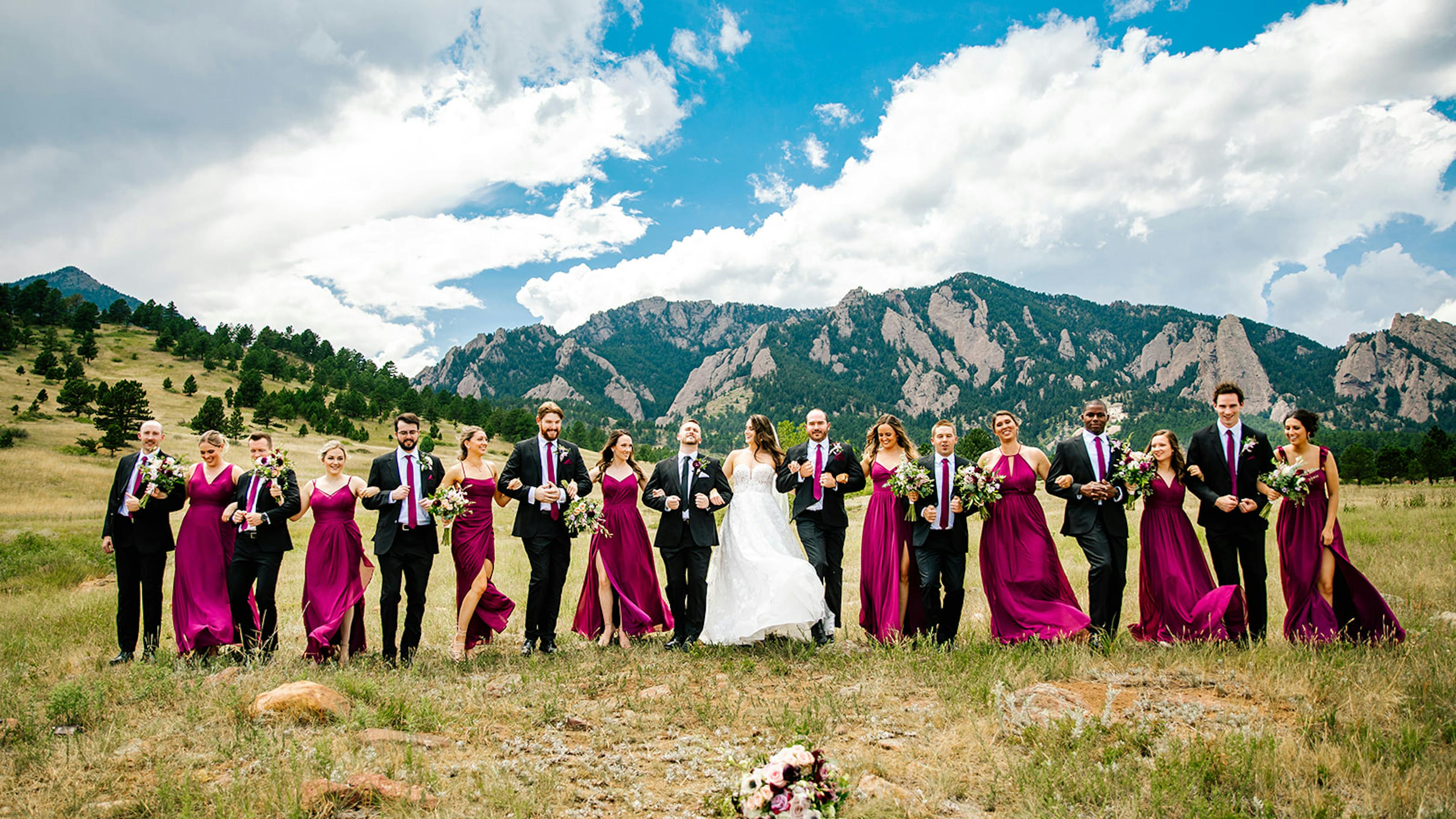 On-trend mountainside wedding party decked out in Pantone's Color of the Year, wearing Viva Magenta bridesmaid dresses and neck ties.