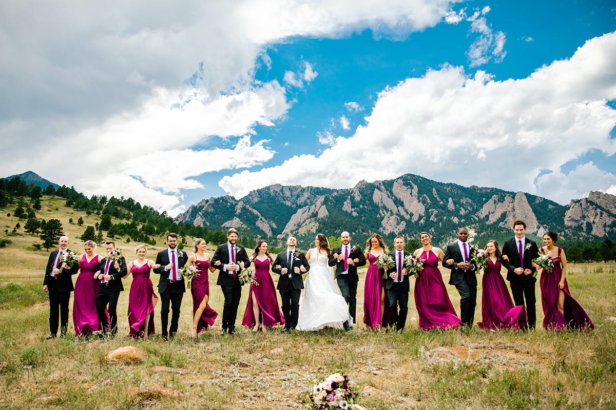 On-trend mountainside wedding party decked out in Pantone's Color of the Year, wearing Viva Magenta bridesmaid dresses and neck ties.