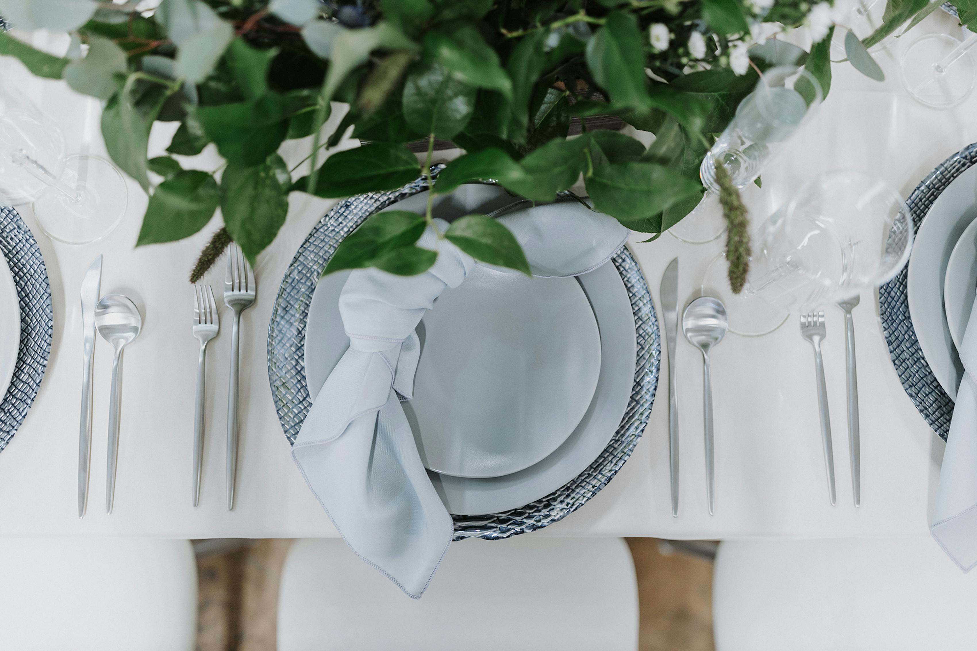 Wedding table design with greenhouse aesthetic and blue wedding color palette