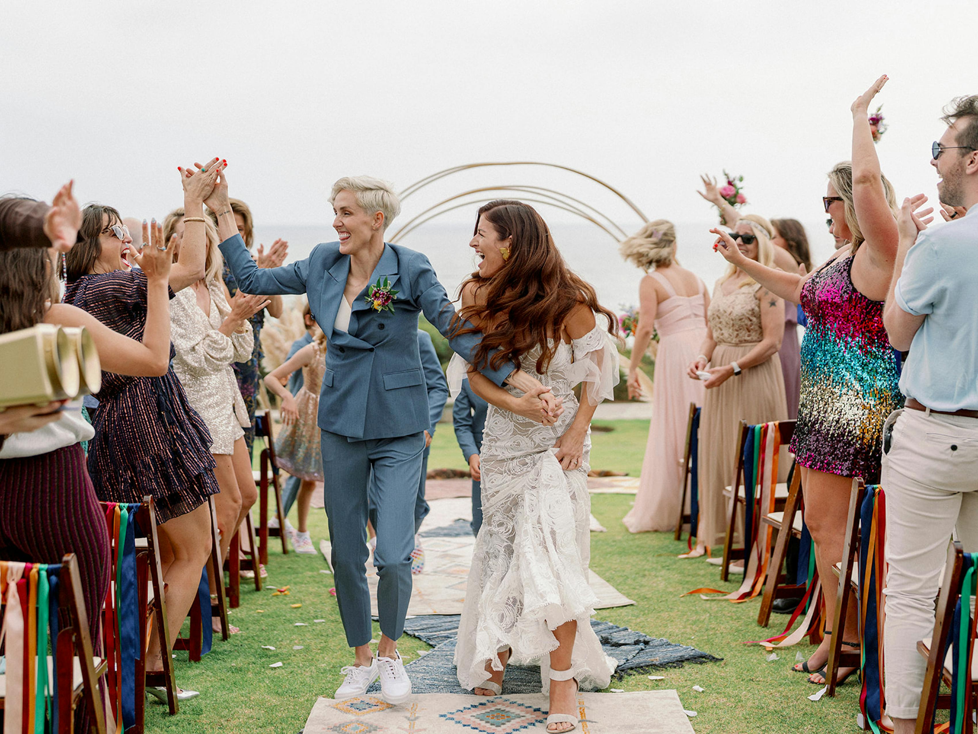 Newly married wives Sally and Lena Osborne celebrating on the wedding aisle.