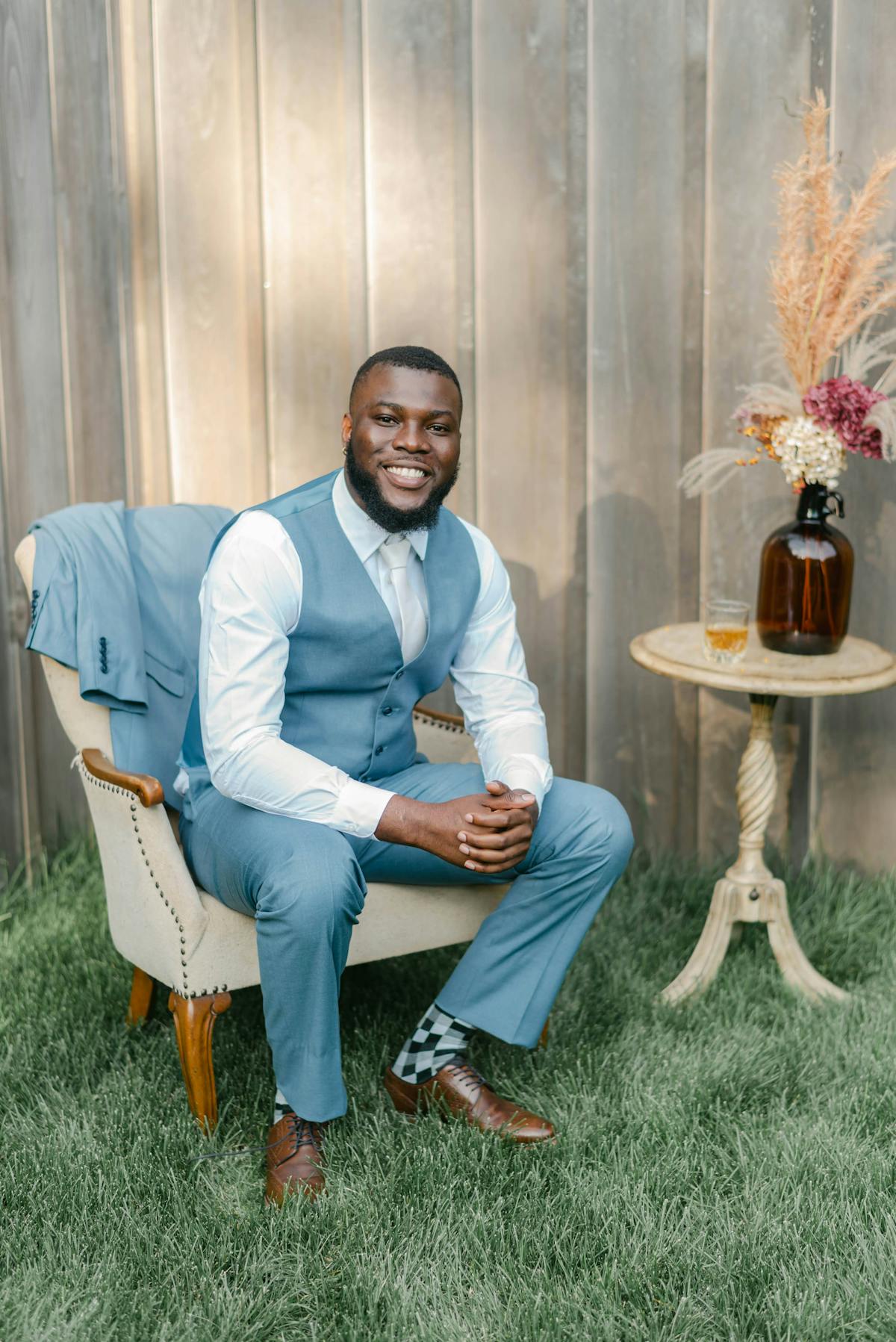 Daytime wedding men's outfit light blue wedding suit and vest with whiskey.