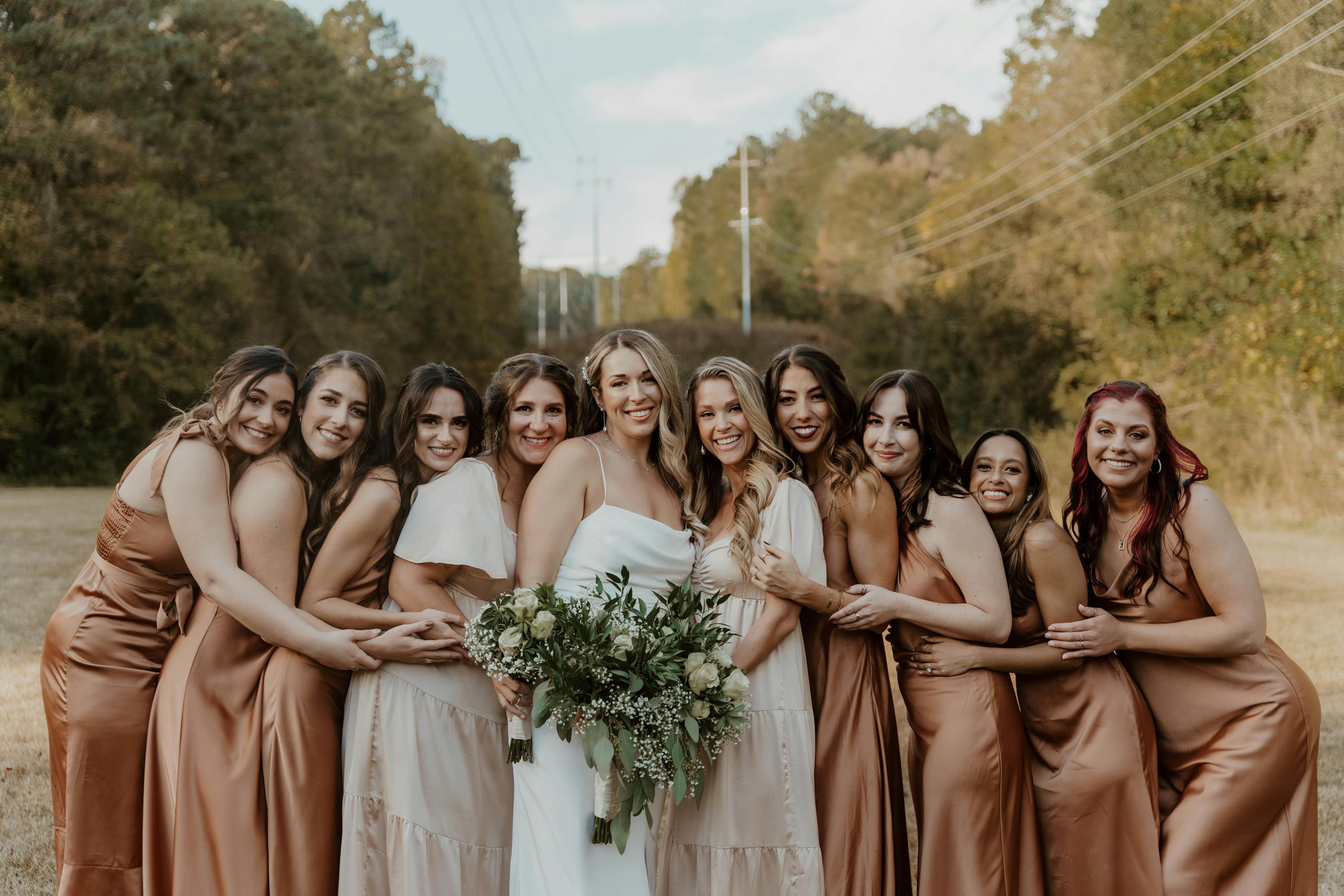 Champagne, rust, and copper bridesmaid dresses in bridal party..