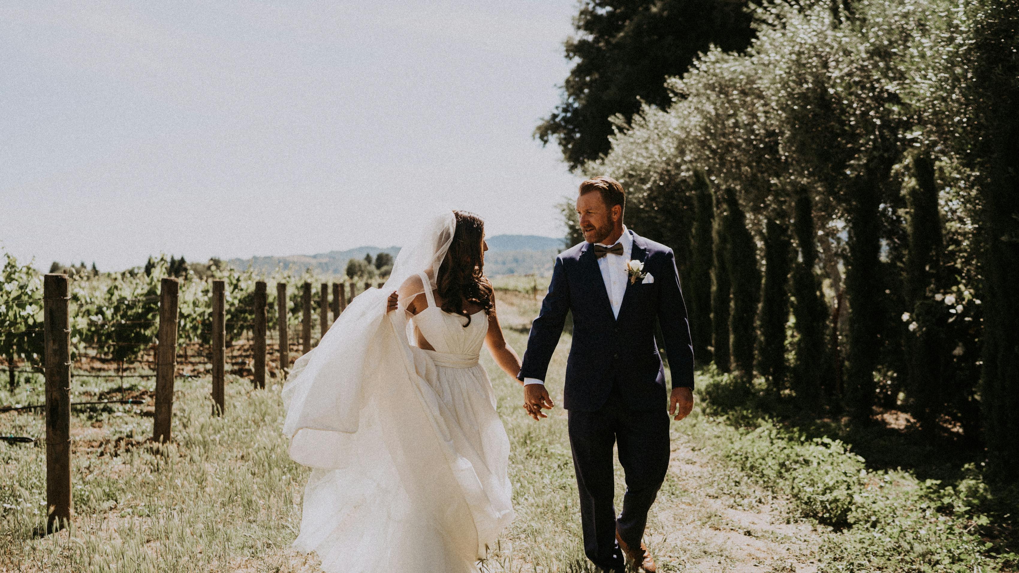 Trendy bride and groom in a vineyard making their own traditions without father of the bride at wedding.