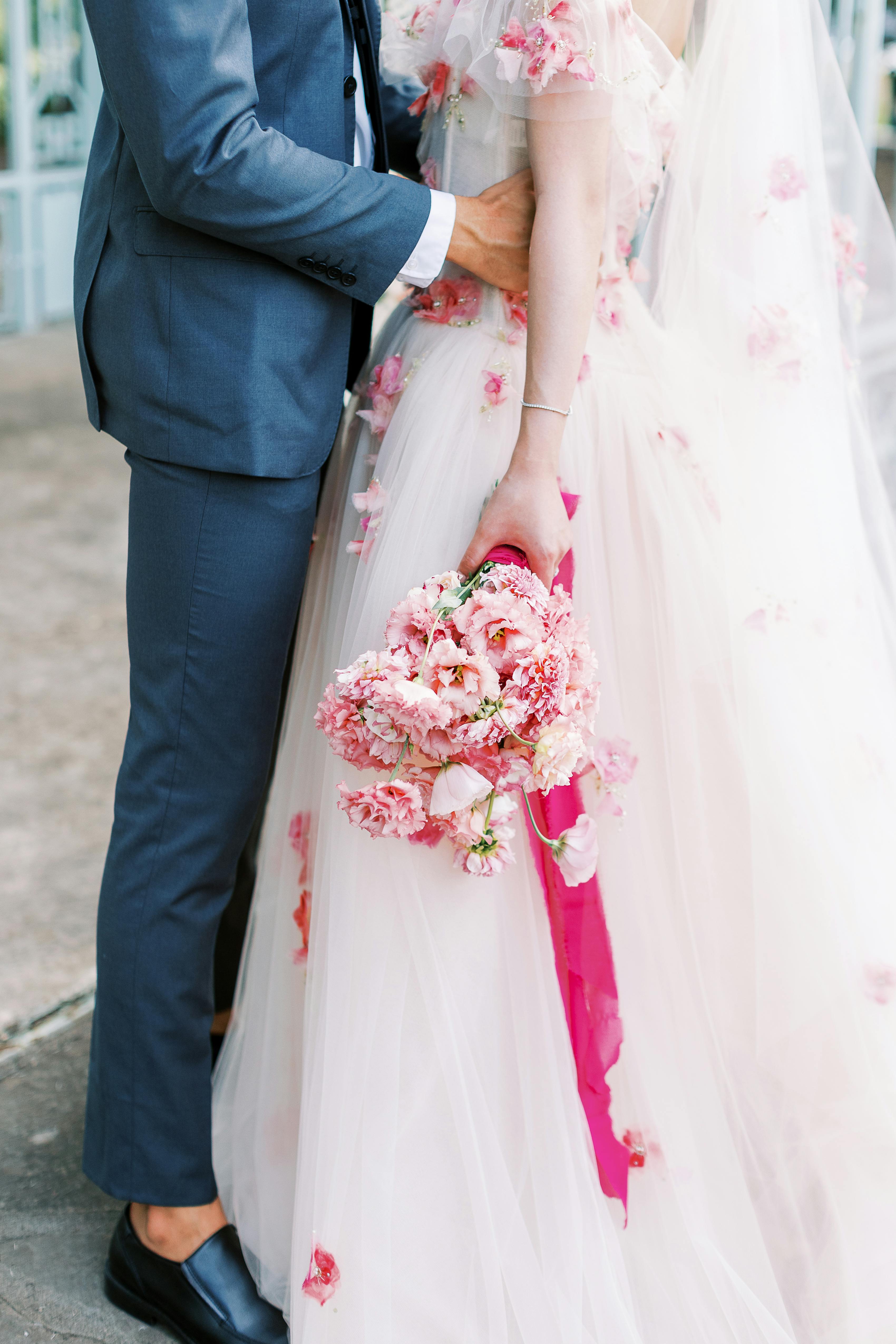 Light blue wedding suit with floral pink wedding gown