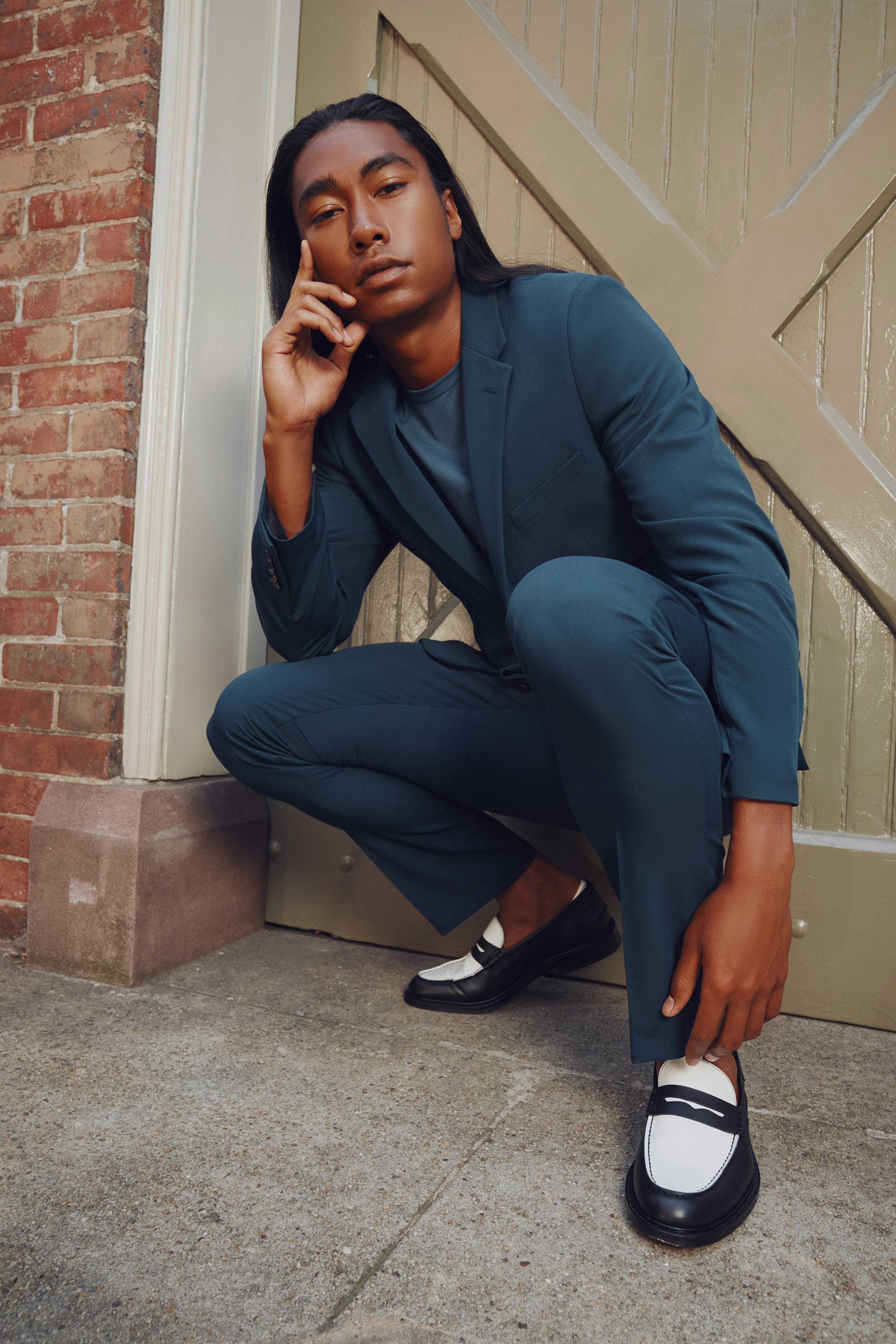 Deep teal men's suit for a monochrome look.