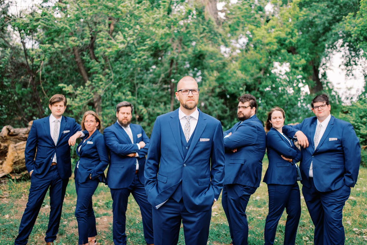 Mix Gendered Wedding Party in Brilliant Blue Fitted Suits, Groom in Vest to Stand Out