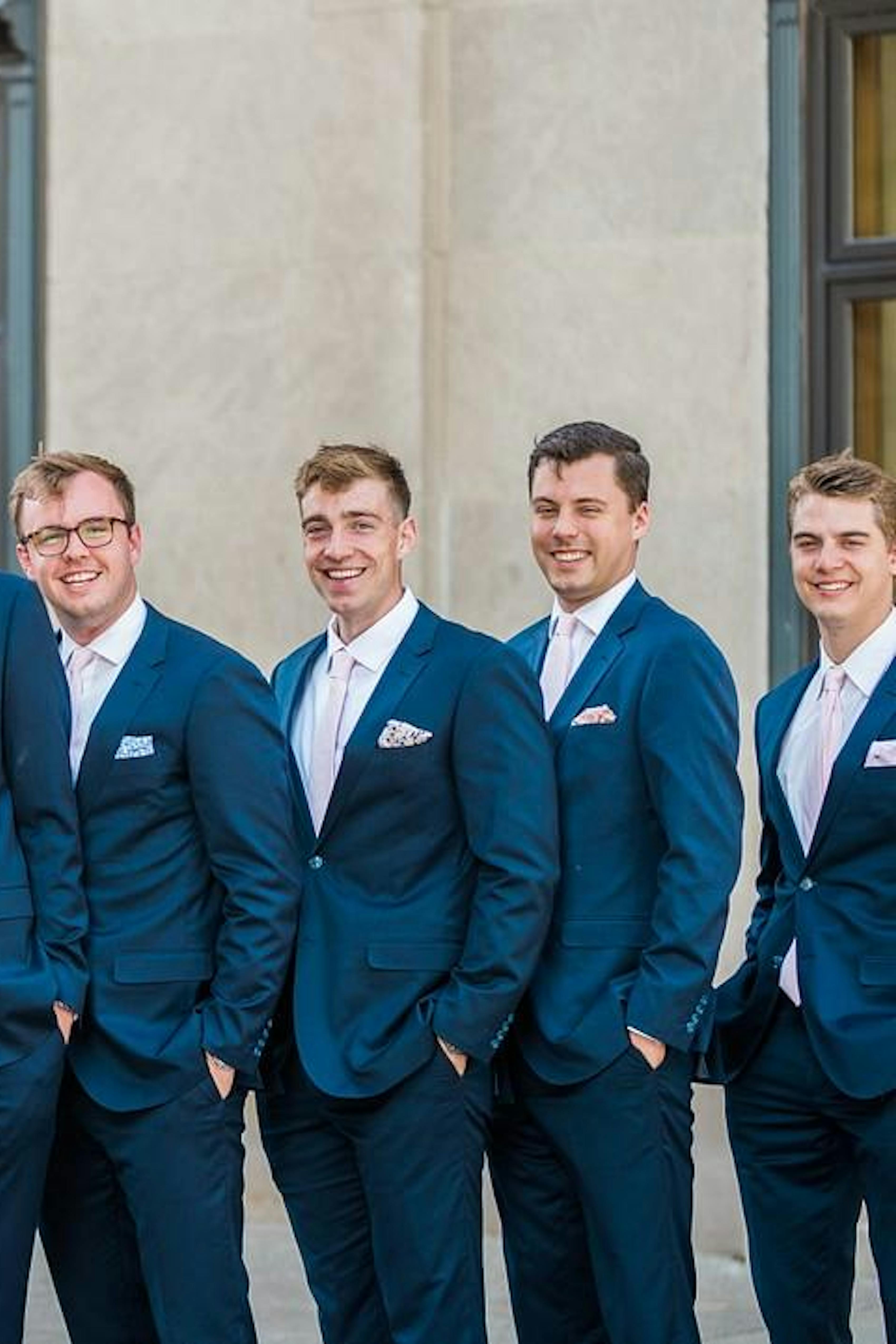 Bright royal blue groomsman suits for blush pink and blue wedding party.