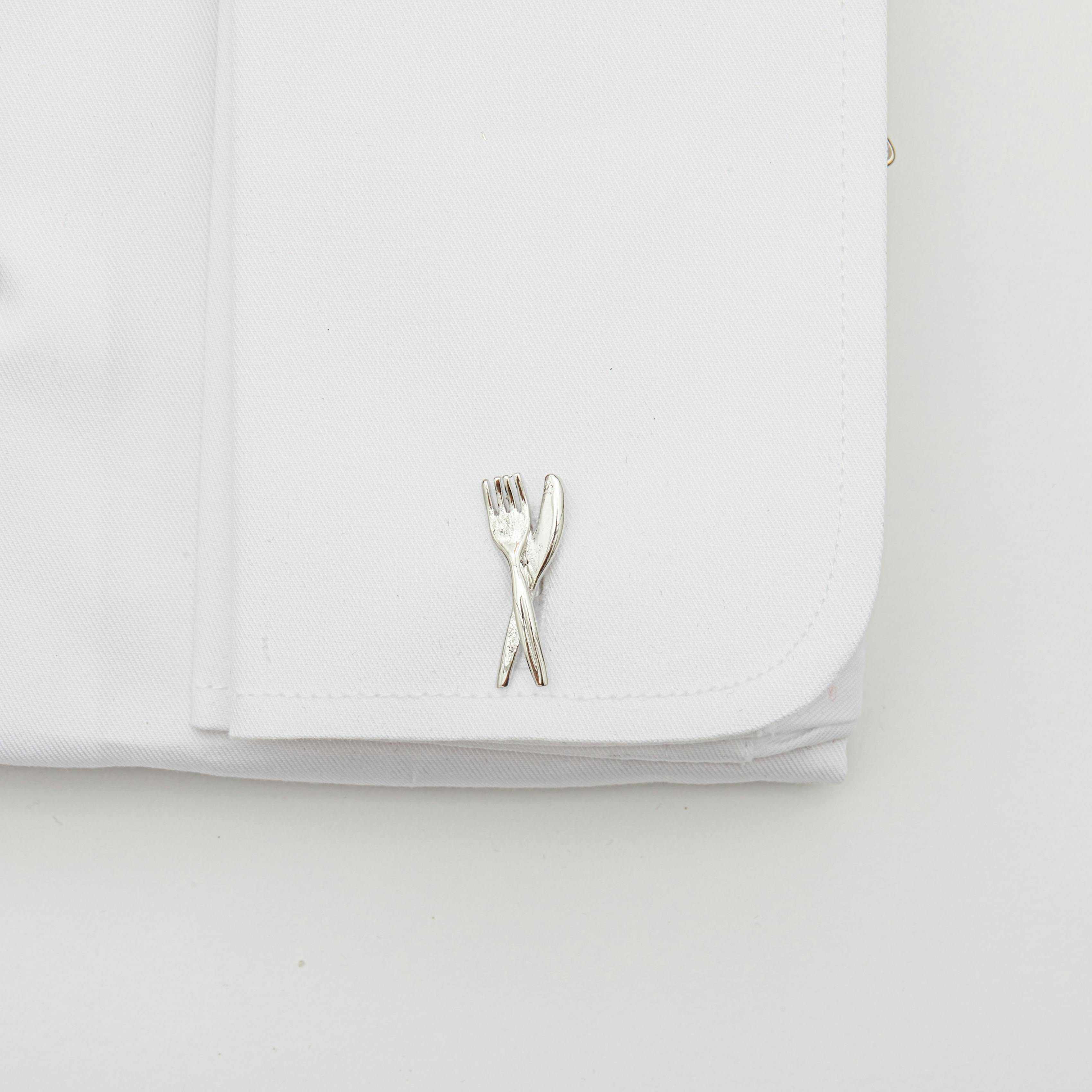 Fork and knife cufflinks on a French cuff dress shirt.