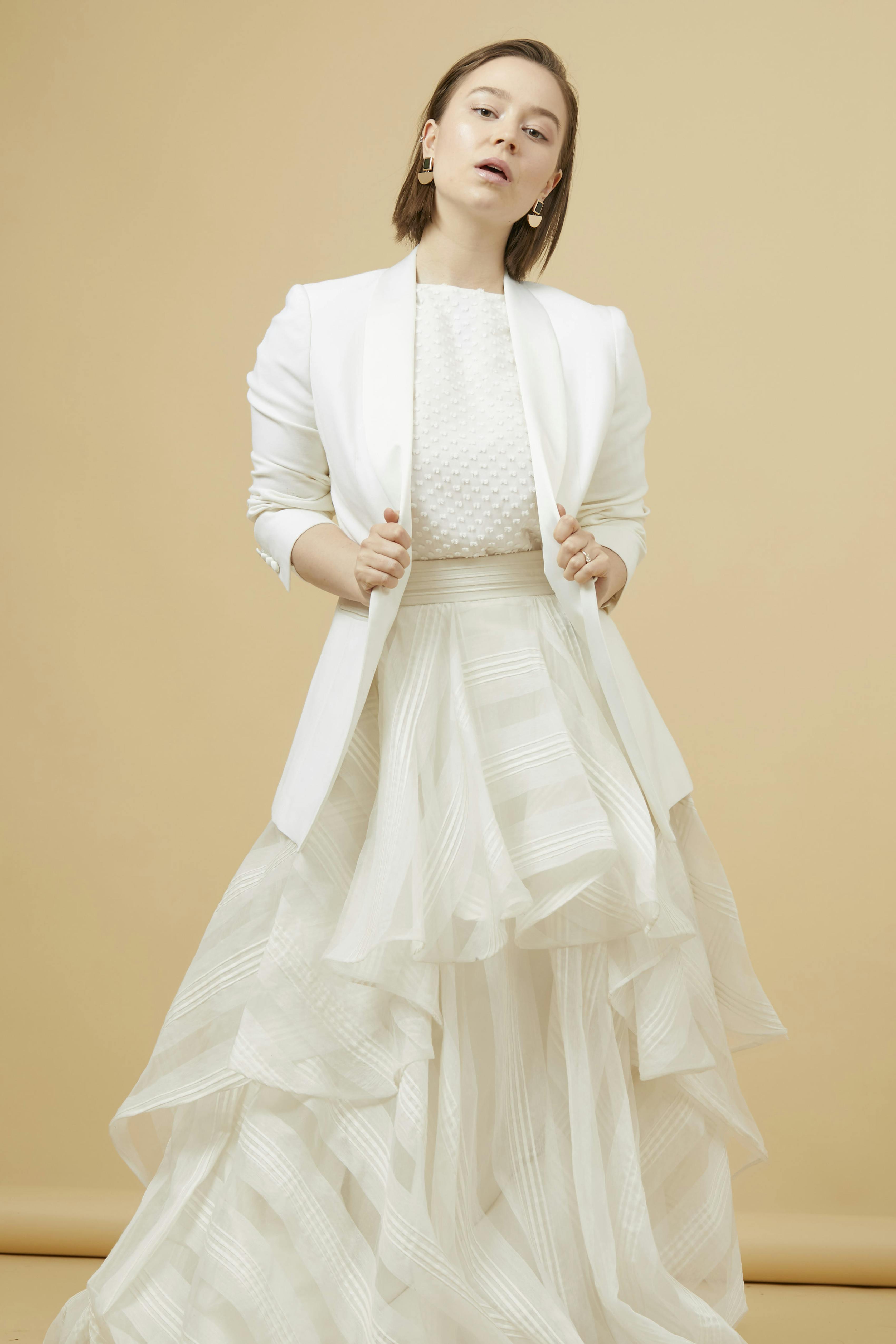 Artsy girl's homecoming outfit for 2022 with layered, full skirt and women's white tuxedo jacket.