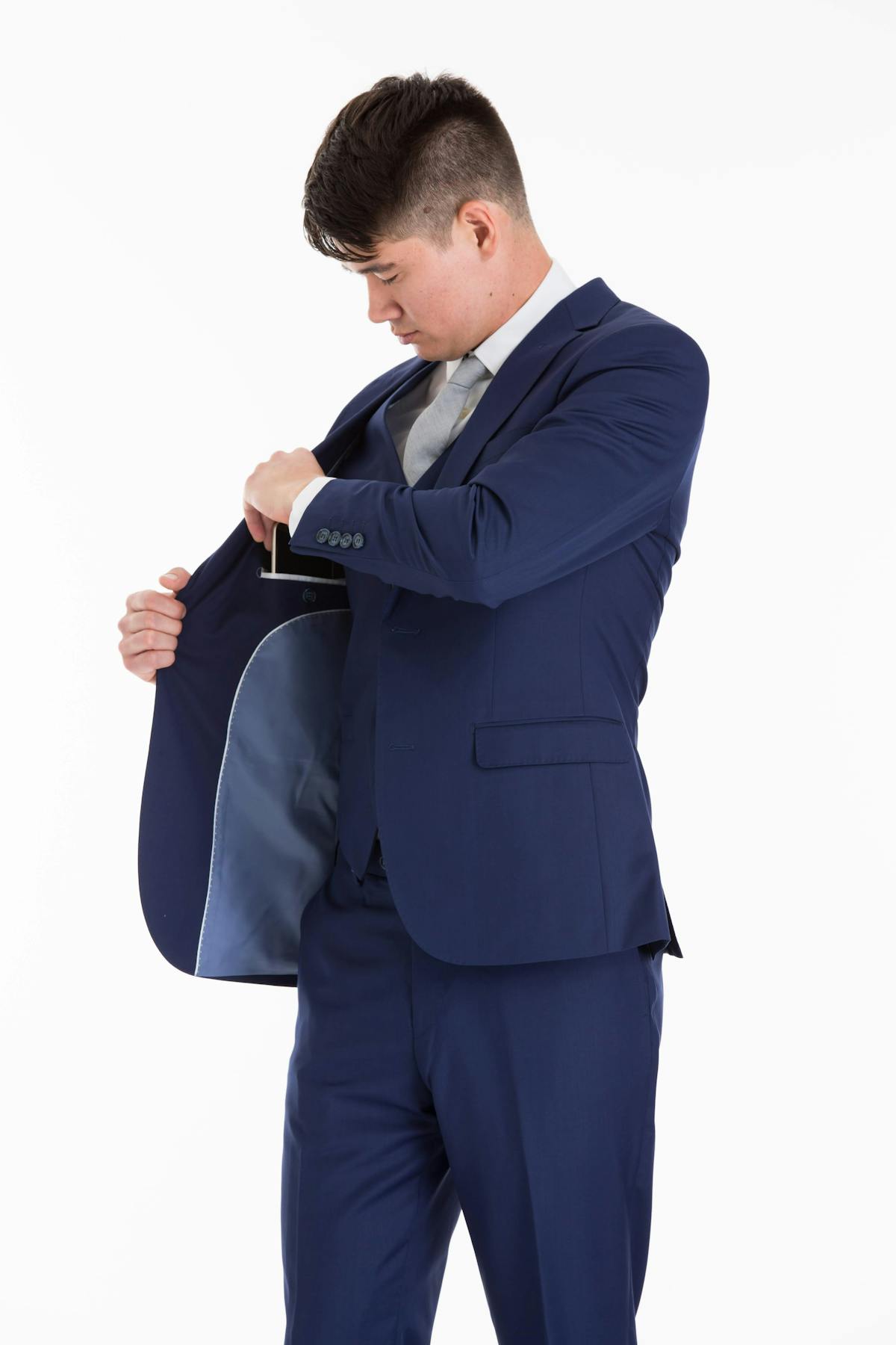 How should I carry my phone, wallet, and keys in my suit pockets?