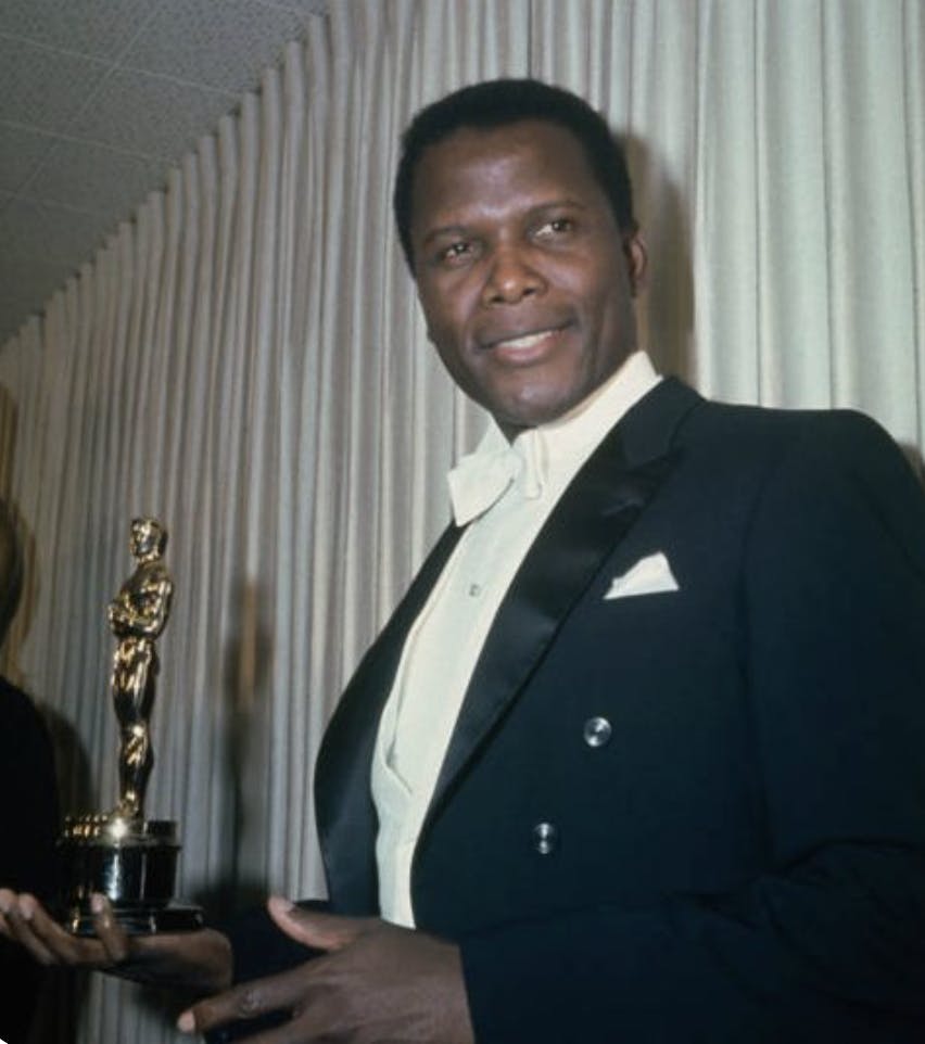 Sidney Poitier in a black tuxedo winning his first Academy Award.