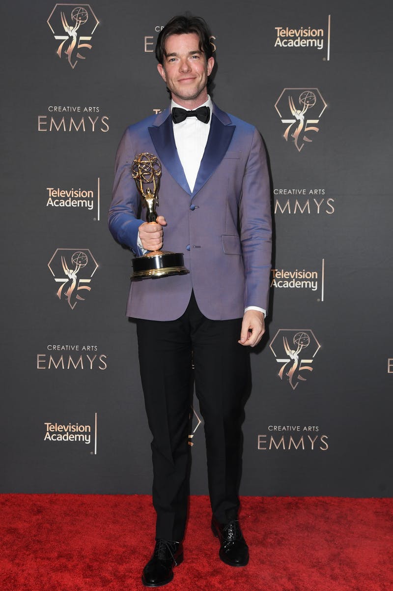 John Mulaney in a modern light blue tuxedo jacket and black tuxedo pants and the 2024 Creative Arts Emmys.