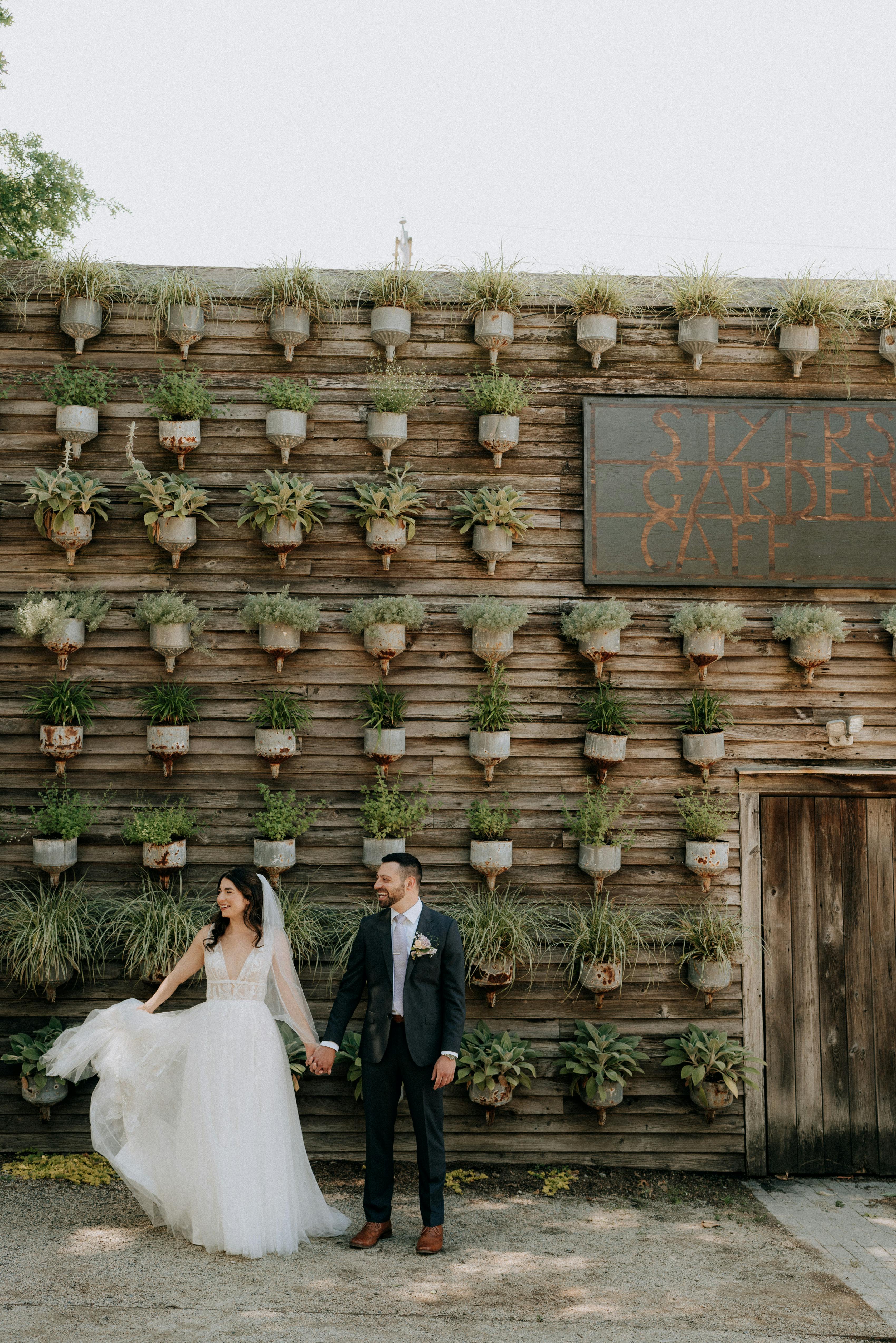 Bride and groom laughing at sustainable wedding with nature theme and succulents plant decor