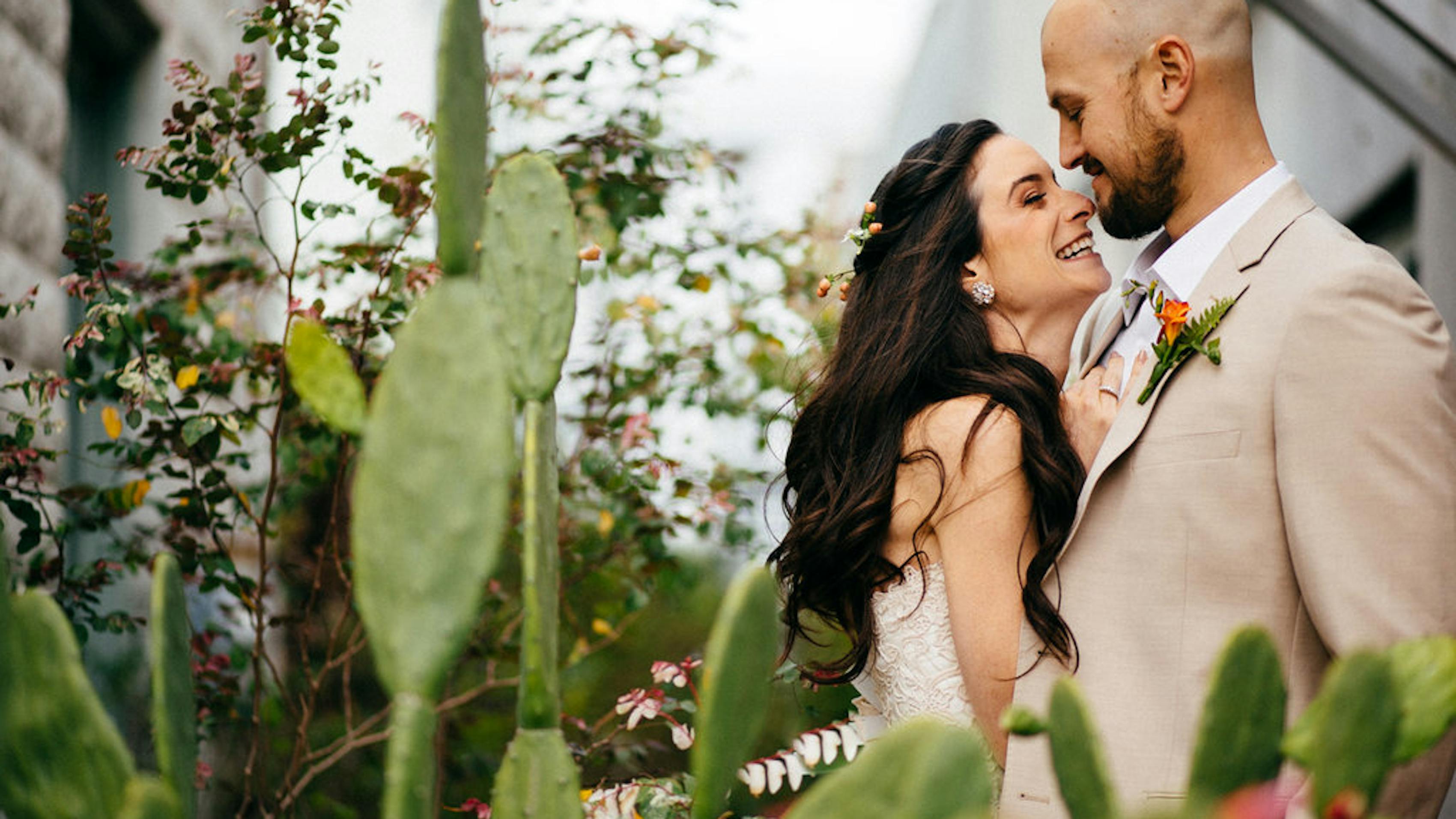 Bride and groom in cactus garden greenhouse venue for eco friendly wedding