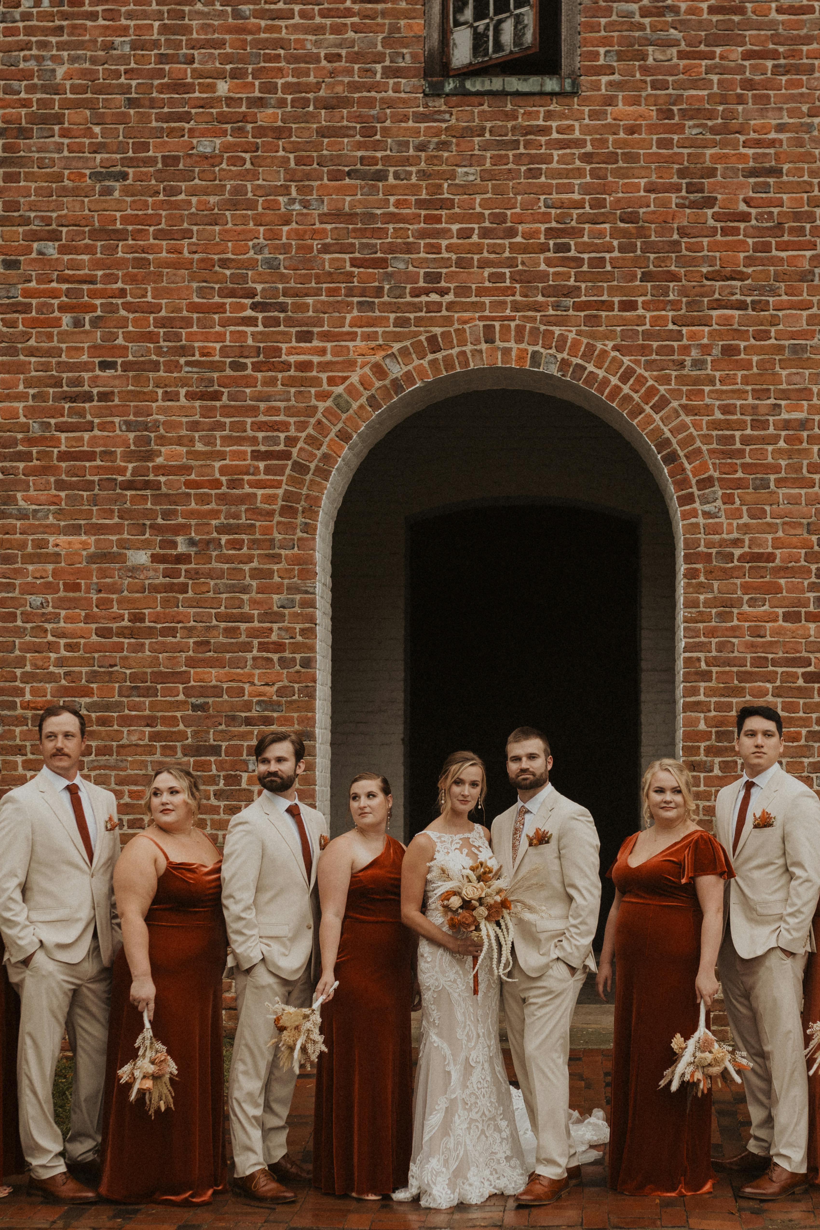 Full bridal party with rewearable bridesmaid dresses and light tan groomsman suits