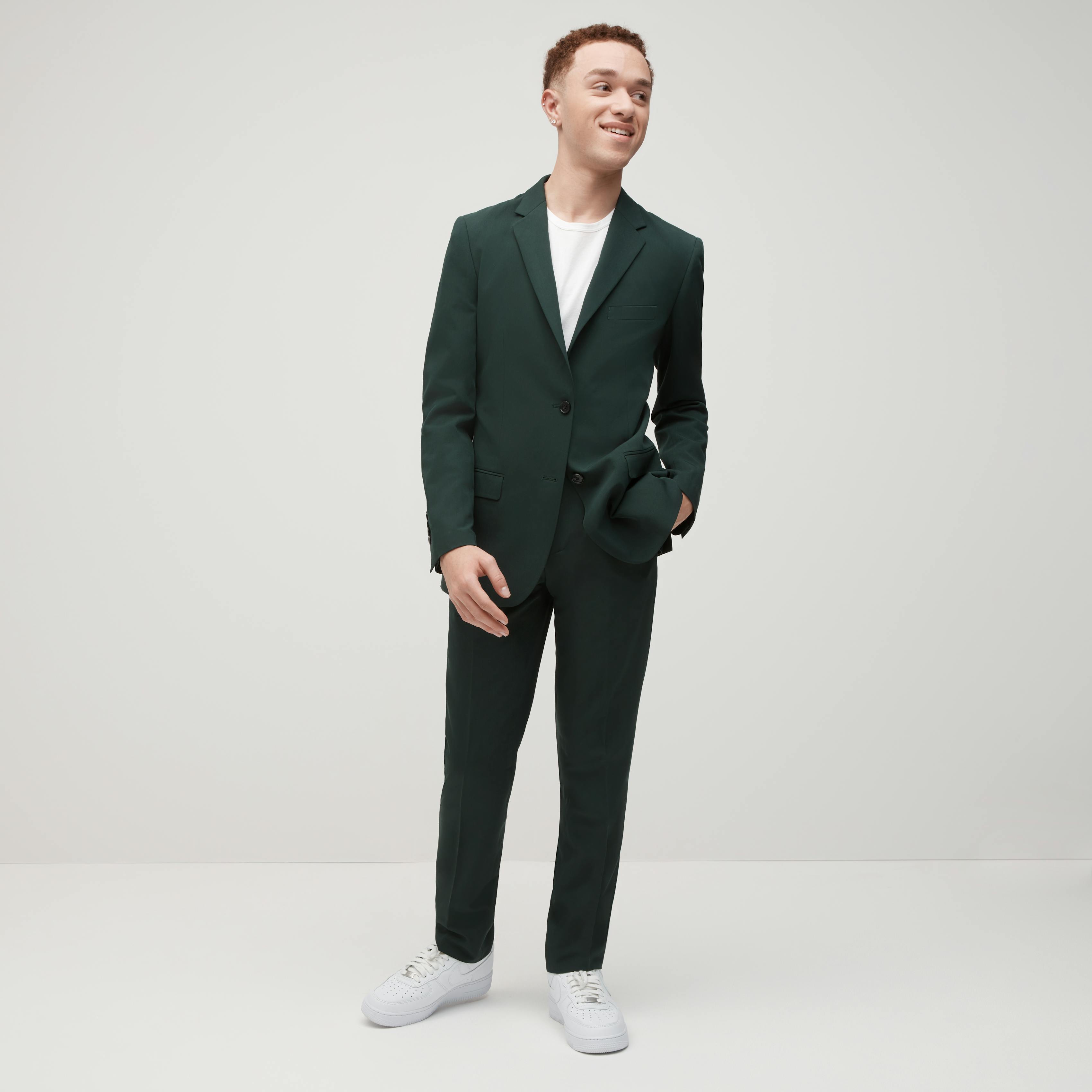 Perfectly fitting prom suit in dark green with sneakers