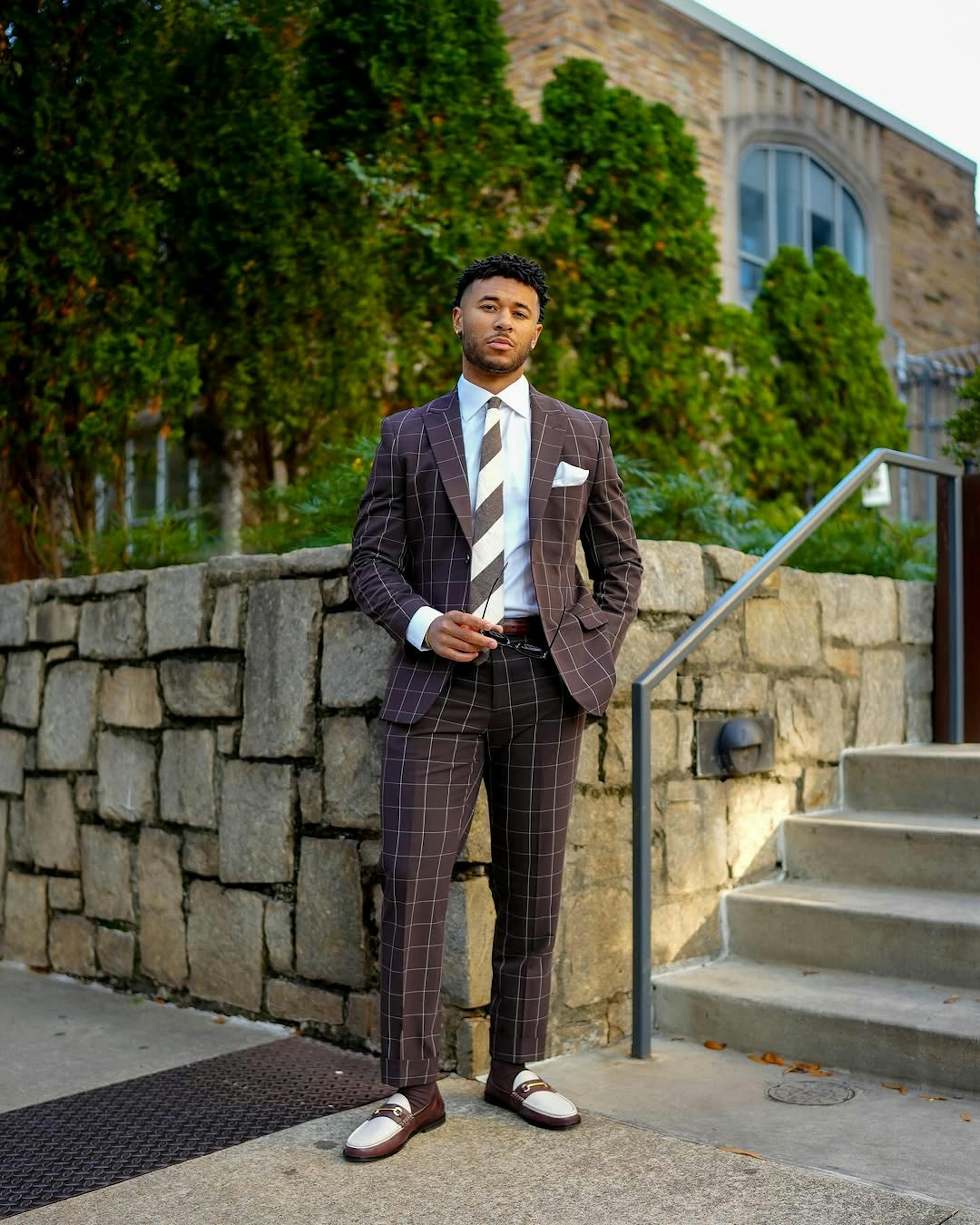 Dressed up for cocktail hour wearing men's brown windowpane suit, accessories, and brown loafers