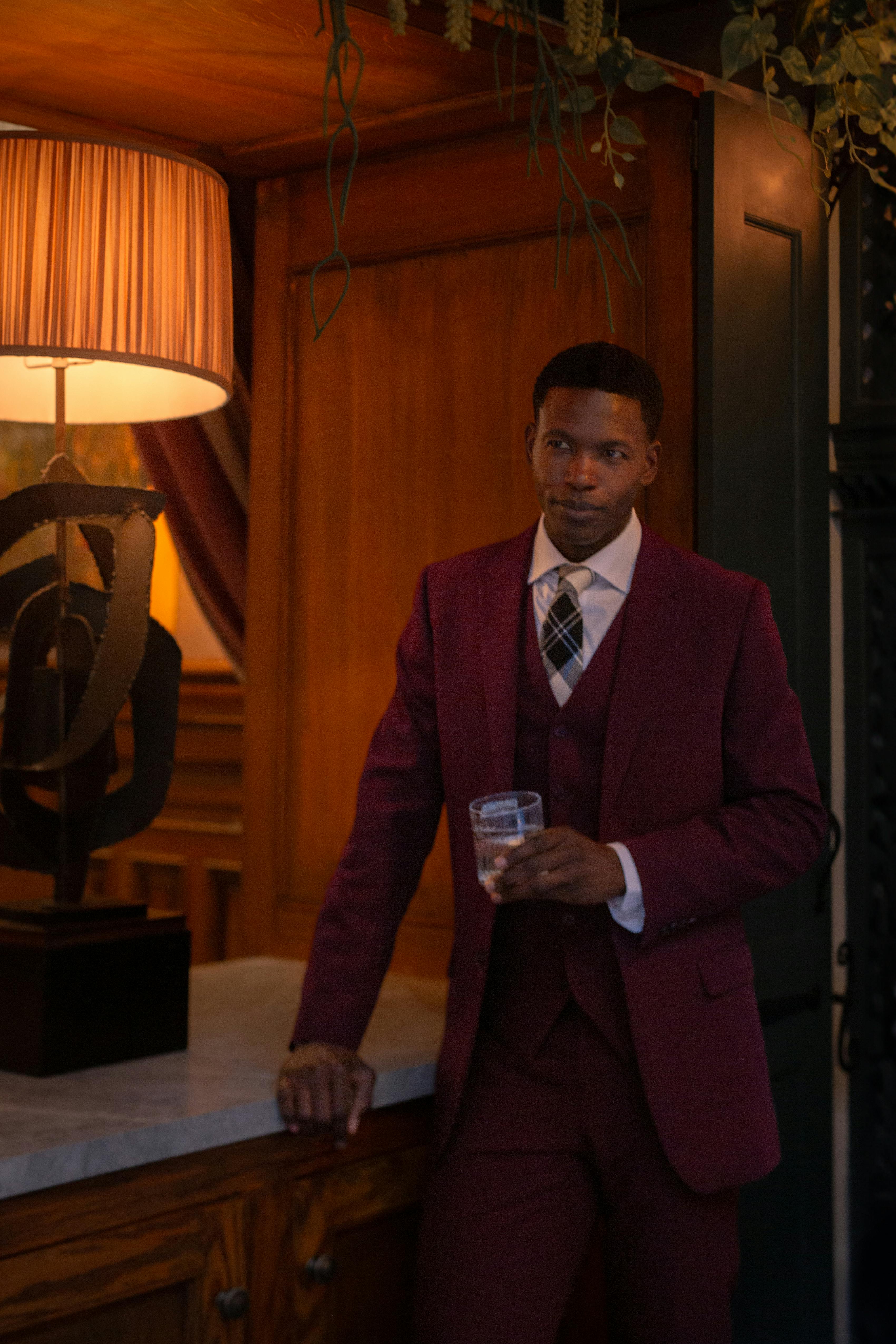 Men's formal holiday party or cocktail attire Christmas party in a burgundy suit