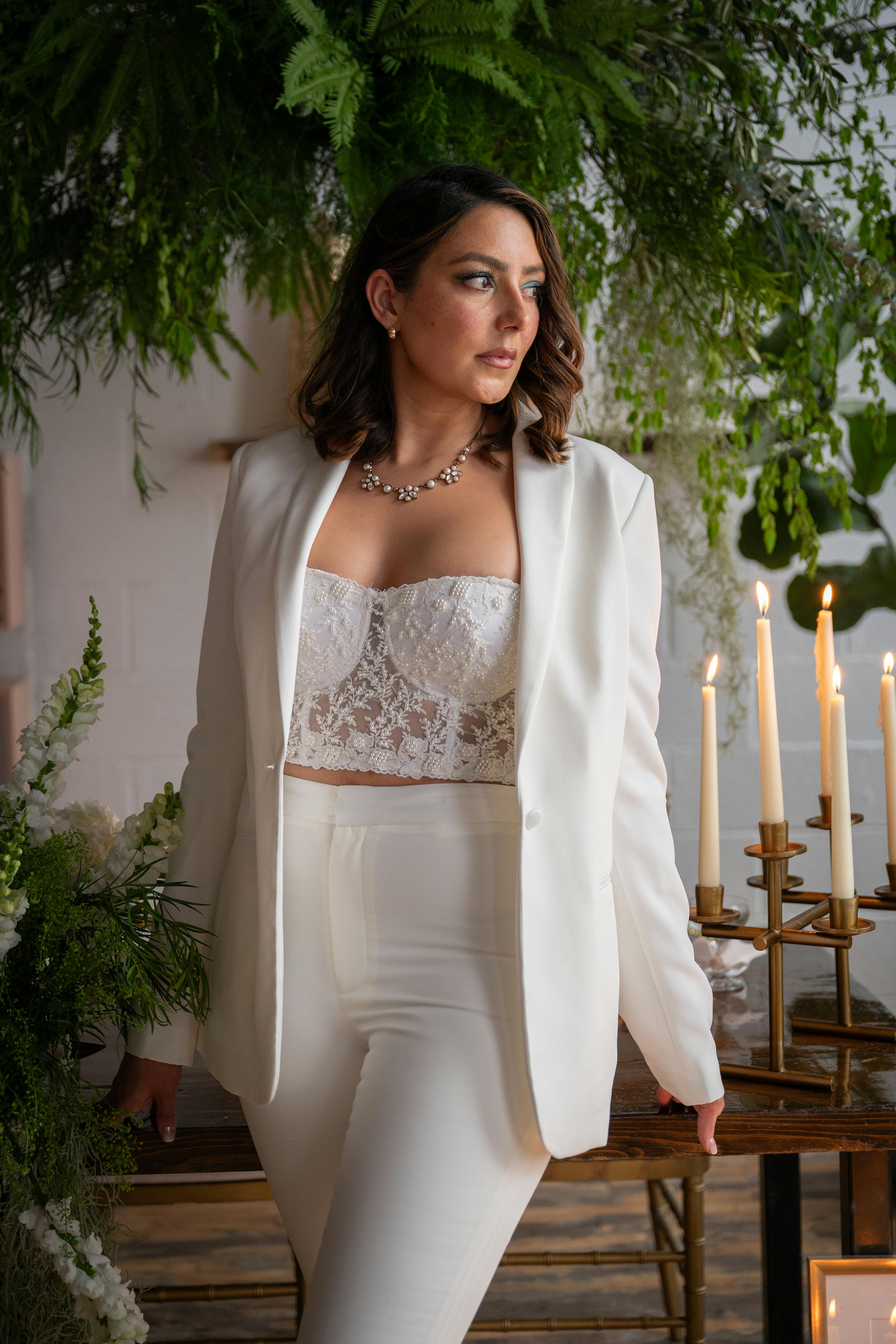 Women's white tuxedo styled with white corset top for holiday party outfit