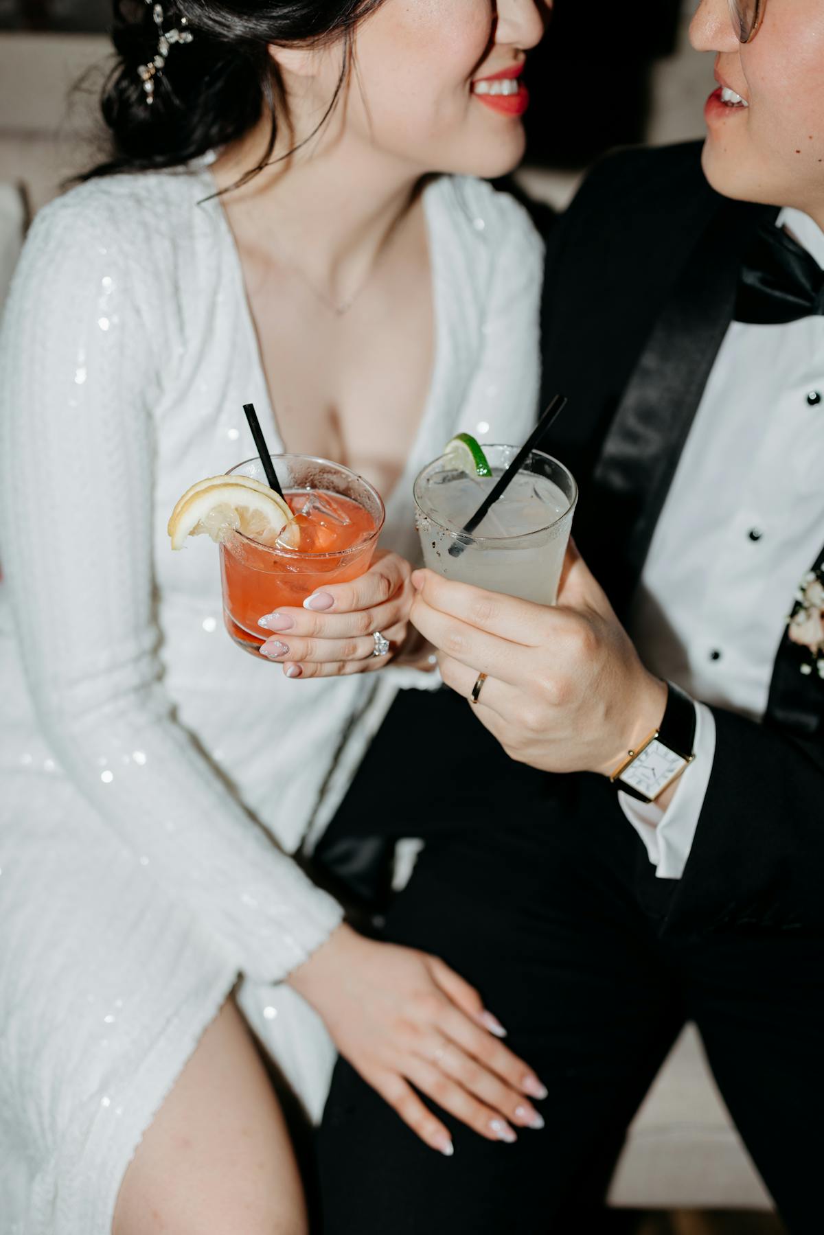 Couple at new year's eve party wearing white sequin dress and black tuxedo