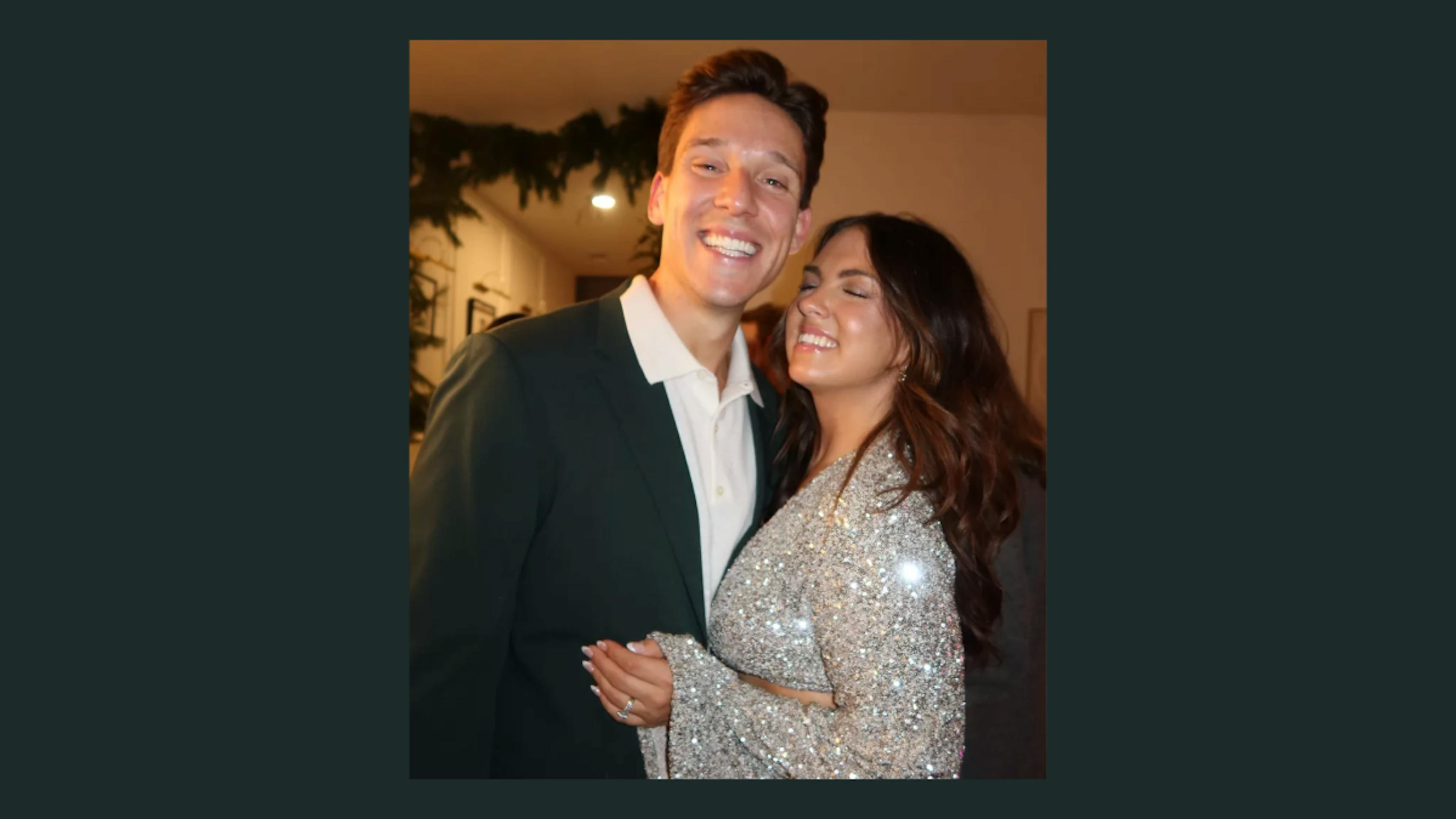 Couple celebrating New Year's Eve wearing a dark green men's suit and a silver sparkly dress