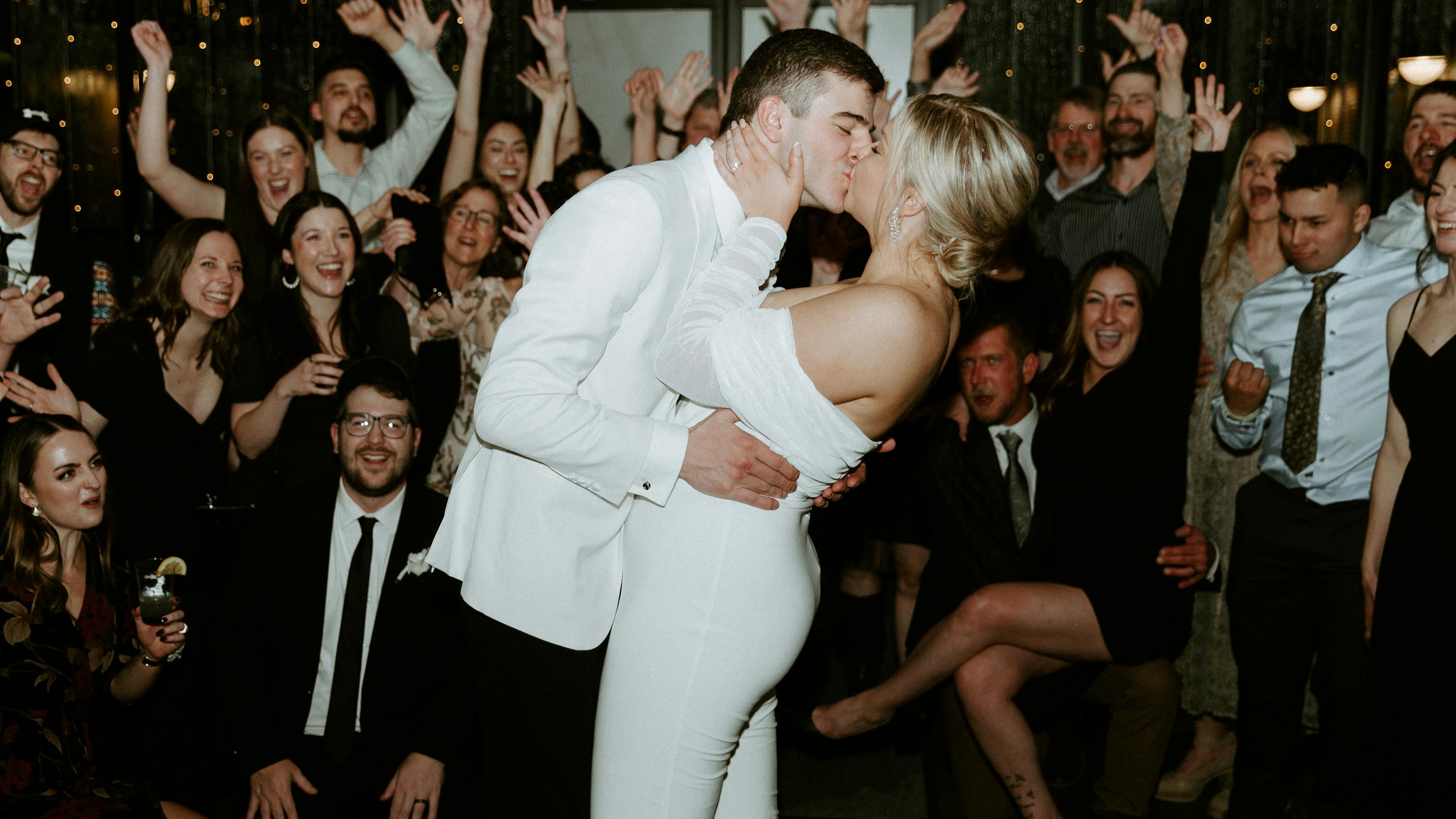 Bride and groom wearing white for all-white wedding reception exit